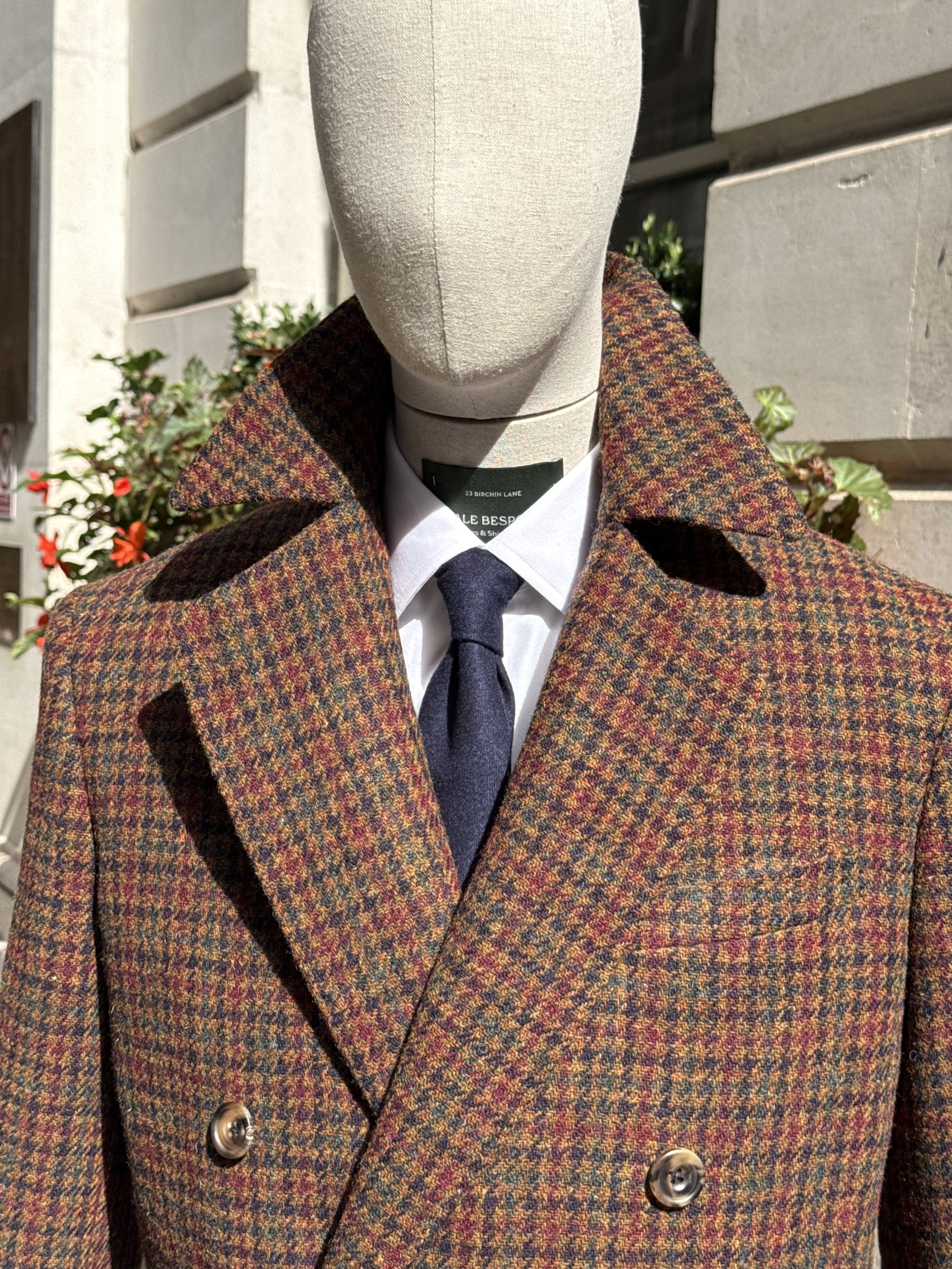 Bespoke double-breasted overcoat in Holland & Sherry Harris Tweed, featuring a richly textured brown, rust and navy check, handcrafted by Kale Bespoke in the City of London.