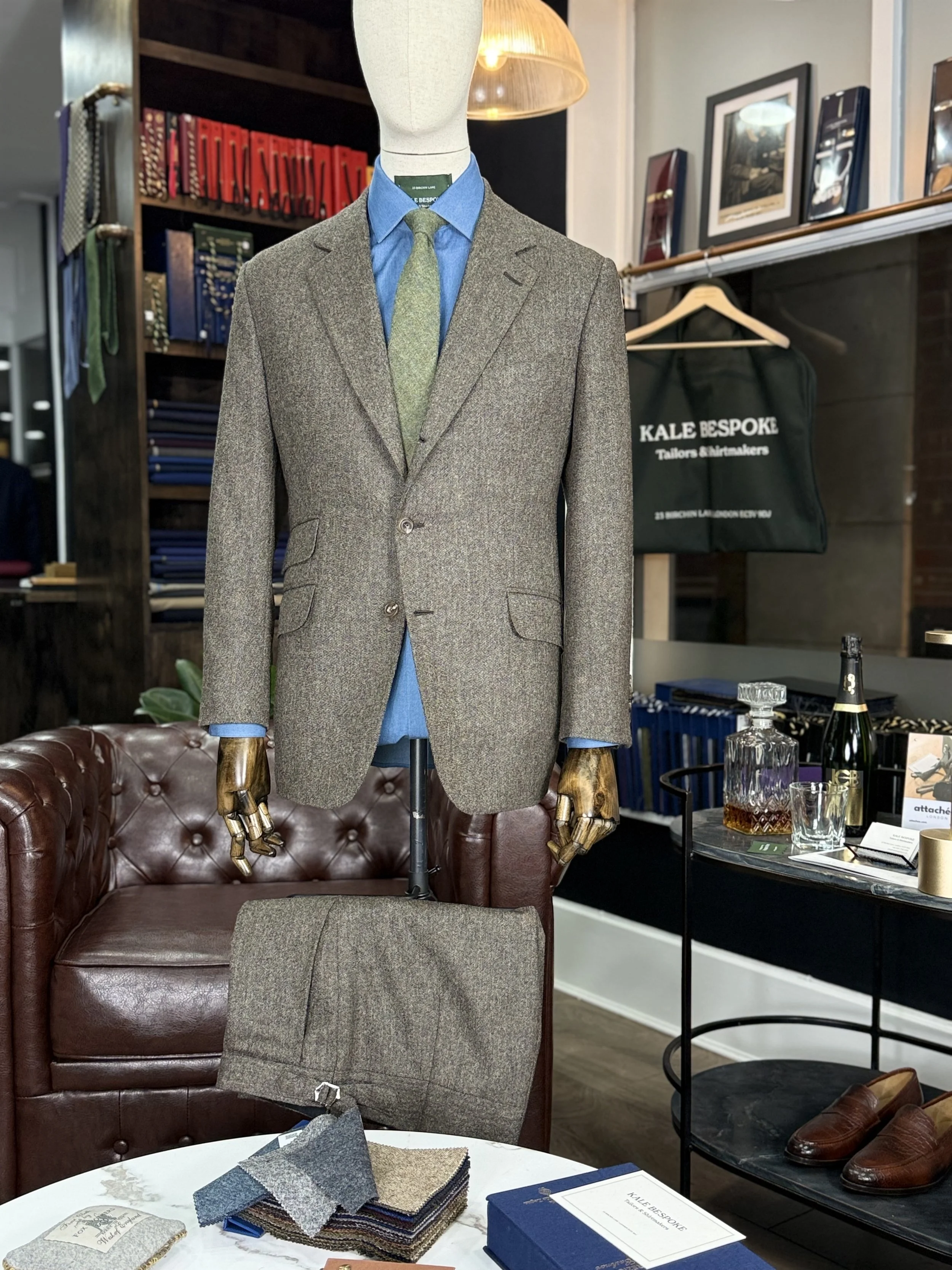 Brown mid-weight Donegal two-piece bespoke suit by Kale Bespoke Tailoring, handmade in London and showcased in our City of London showroom. Featuring a classic 3 roll 2 button jacket with slanted pockets and a ticket pocket, styled with a bespoke cha
