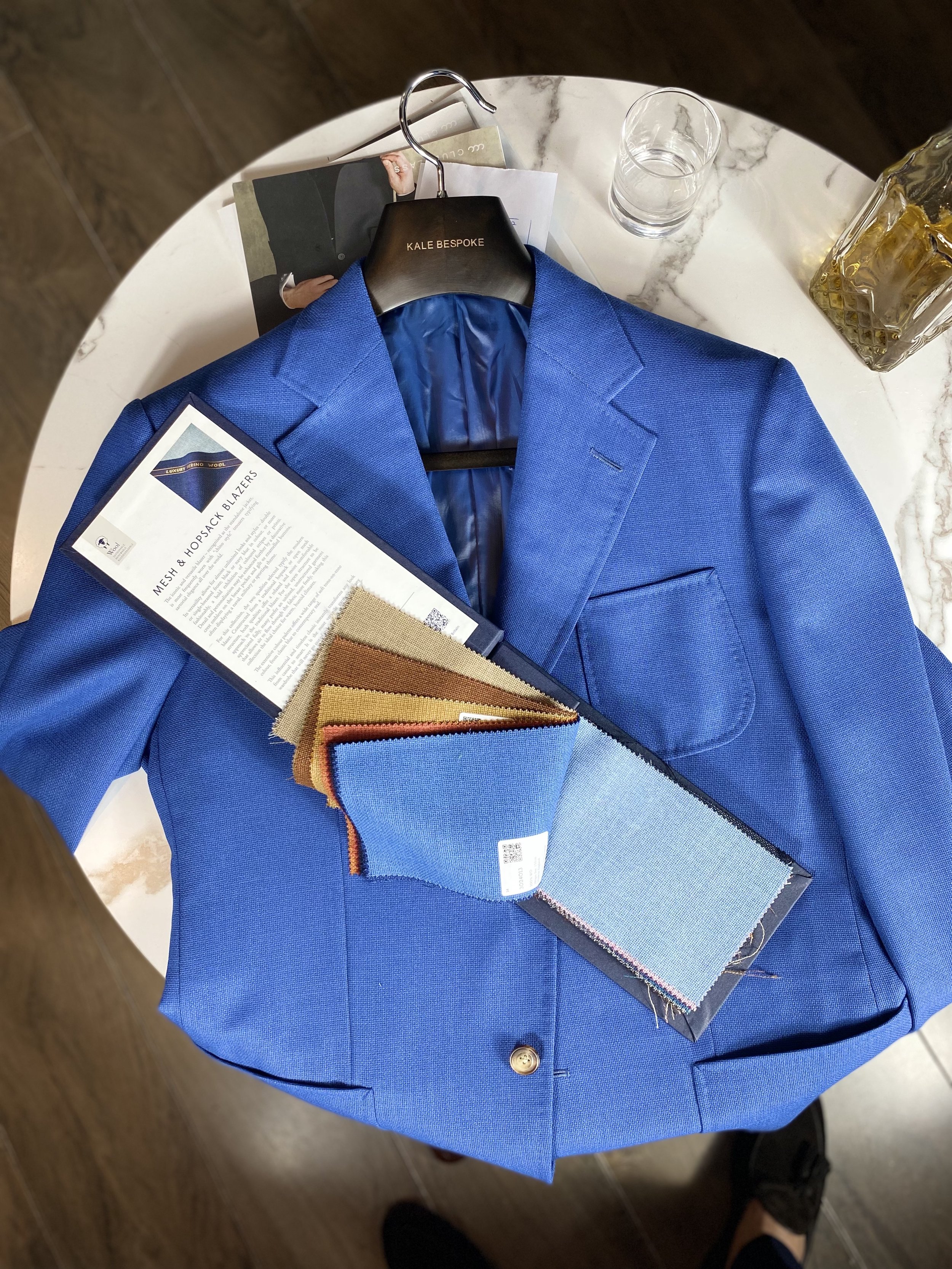 Crafted from luxurious Holland & Sherry mesh and hopsack basket-weave fabric, this sophisticated blue blazer combines timeless tailoring with effortless modern elegance. Designed with a classic notch lapel, patch pockets, and structured silhouette, i