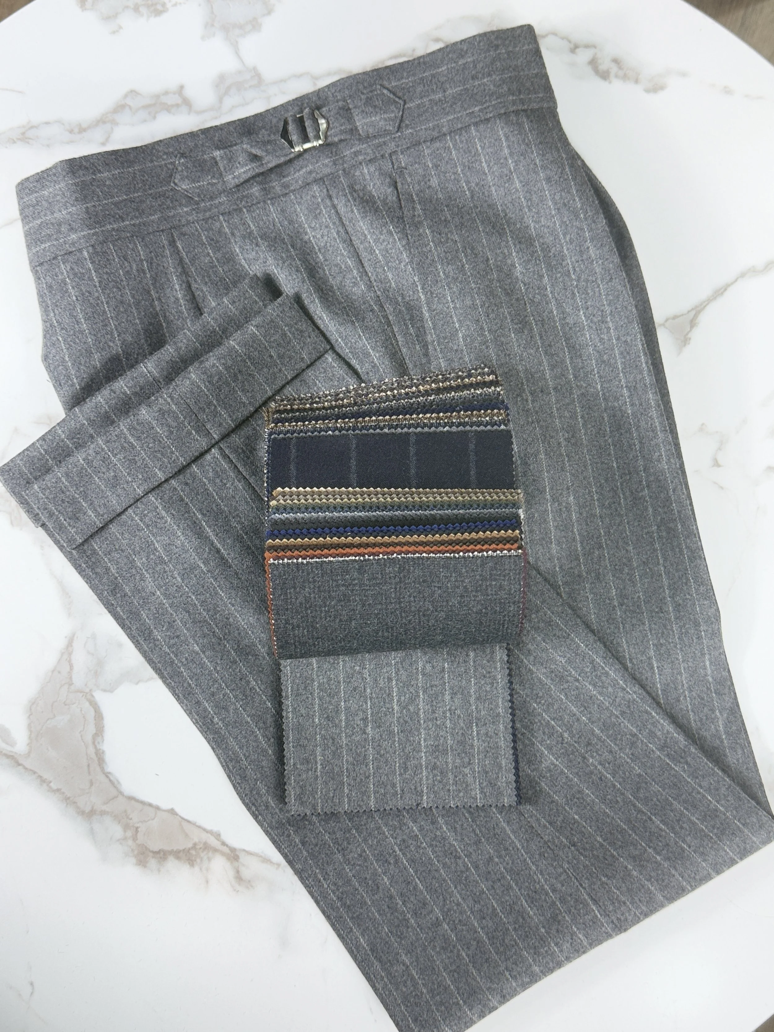 Grey pinstripe flannel trousers with fox brother cloth book.