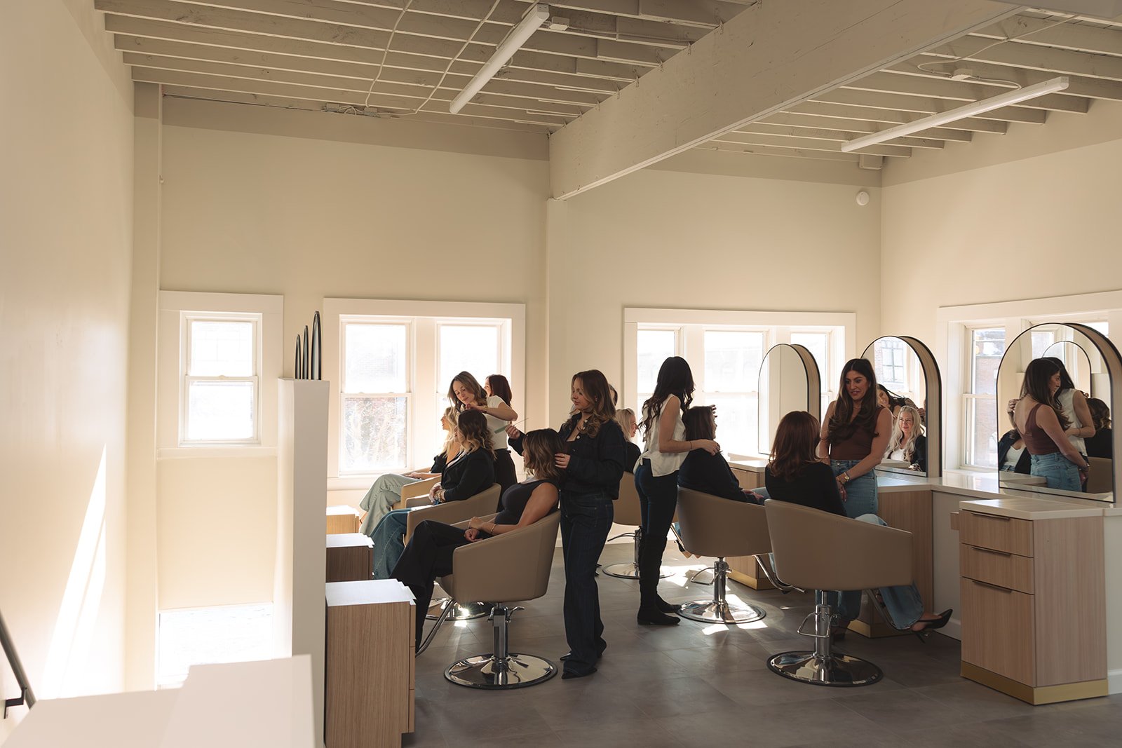 Bobbi Grosse Pointe experts stylists at the salon with large mirrors, natural light, and modern decor.