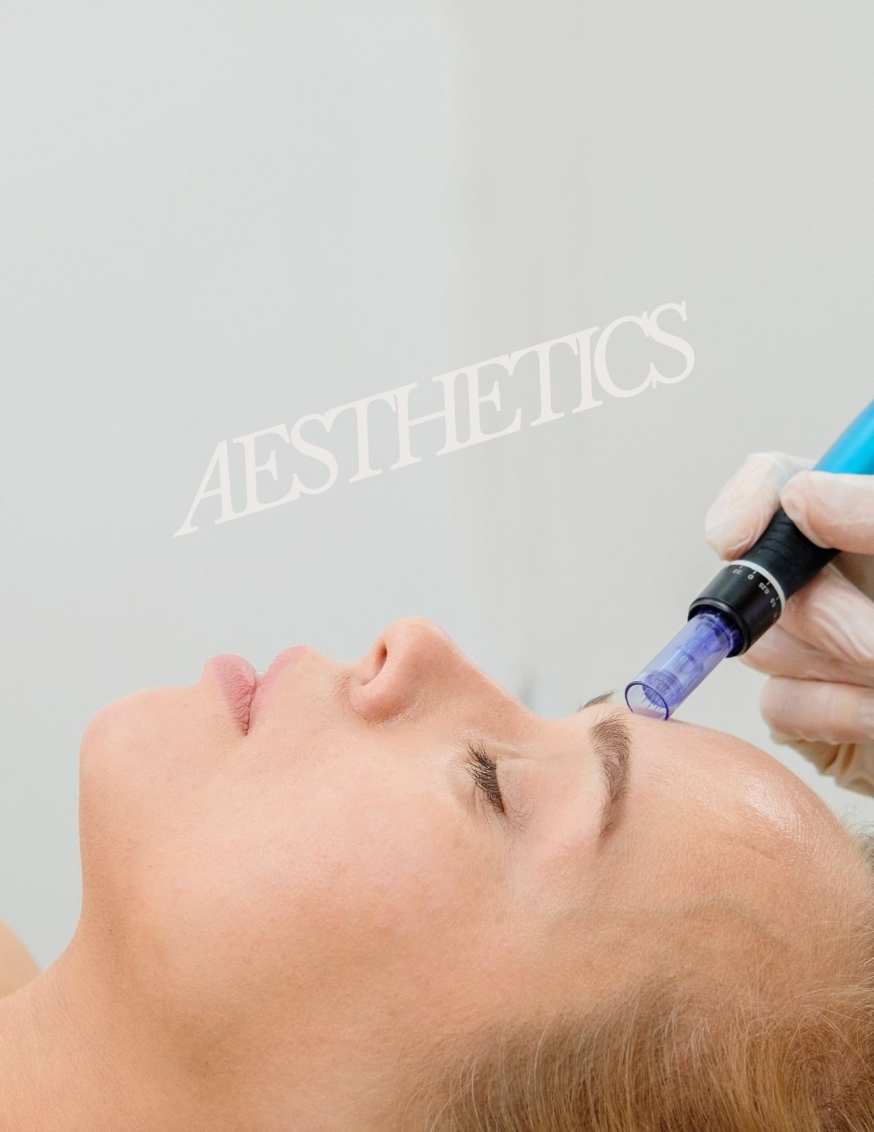 A woman receiving a facial skincare treatment at a clinic or spa, with the word 'AESTHETICS' written on the wall in the background.