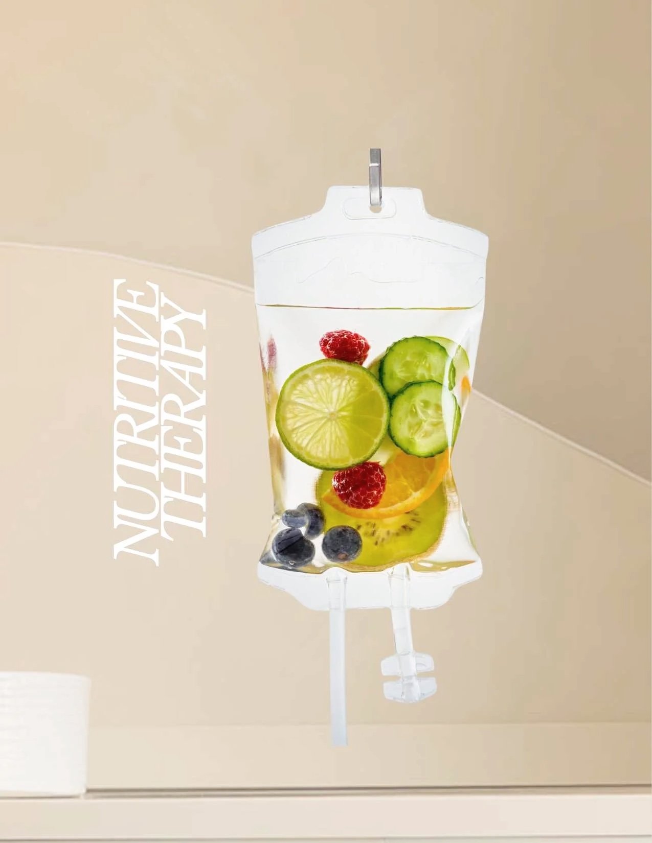 A clear IV drip bag filled with sliced fruits including cucumbers, lemons, raspberries, blueberries, and kiwi.