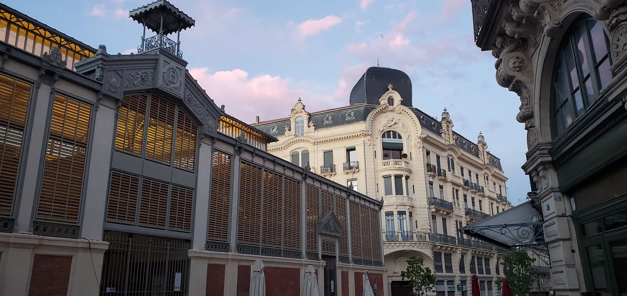 Les Halles de Béziers exterior at golden hour — the renovated Baltard-style covered market