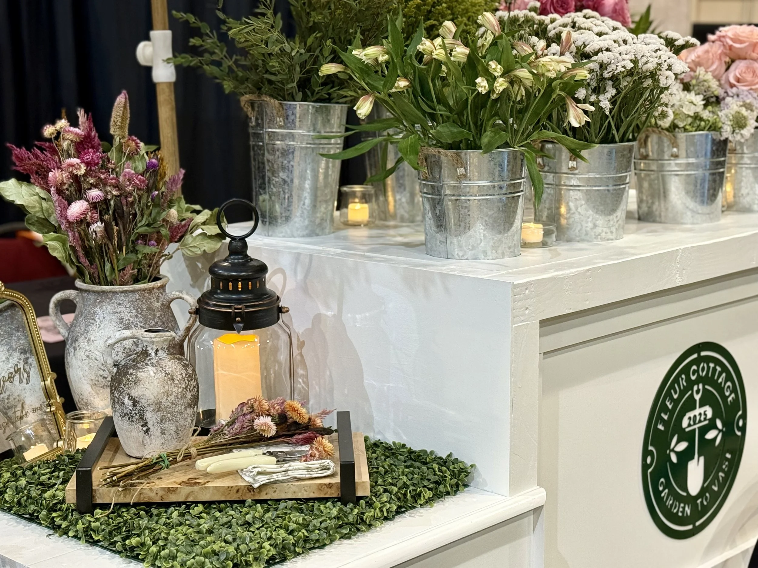 Flower cart with vases of pink and white flowers. Renting our flower cart for your event adds a stylish, interactive element that your guests will love.