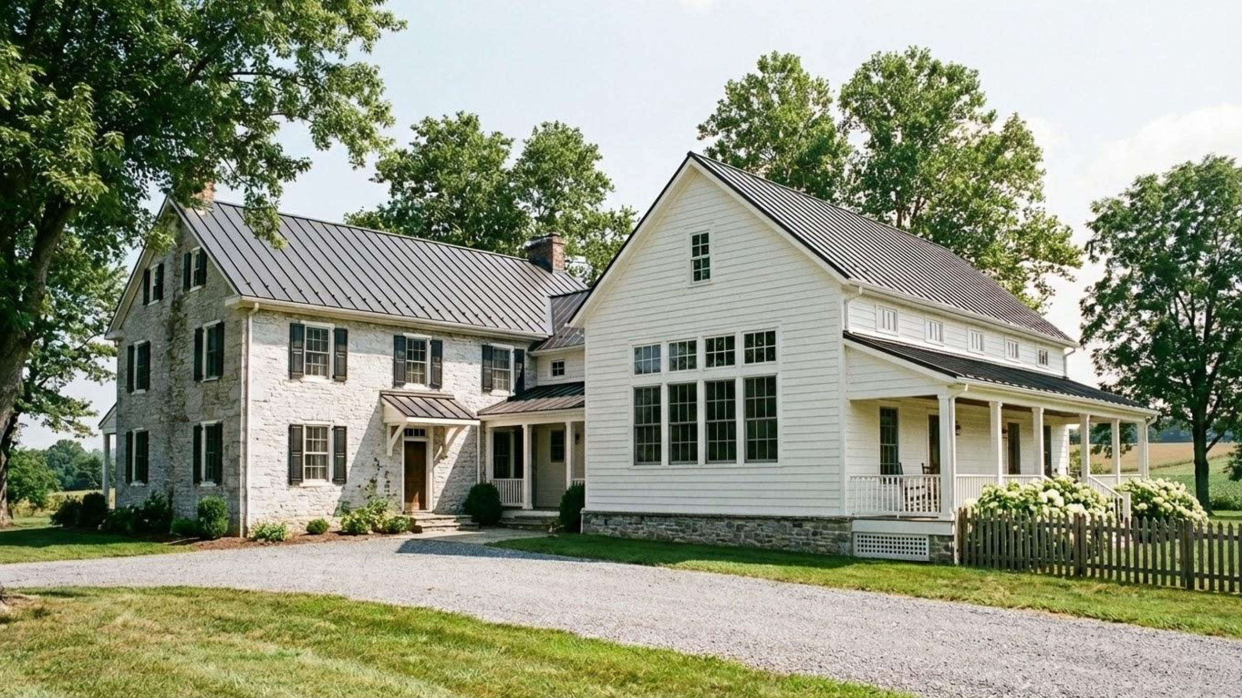A luxury white custom farmhouse in Southeastern Pennsylvania designed by Fresh Start Designs, featuring a metal roof and sprawling green landscape.