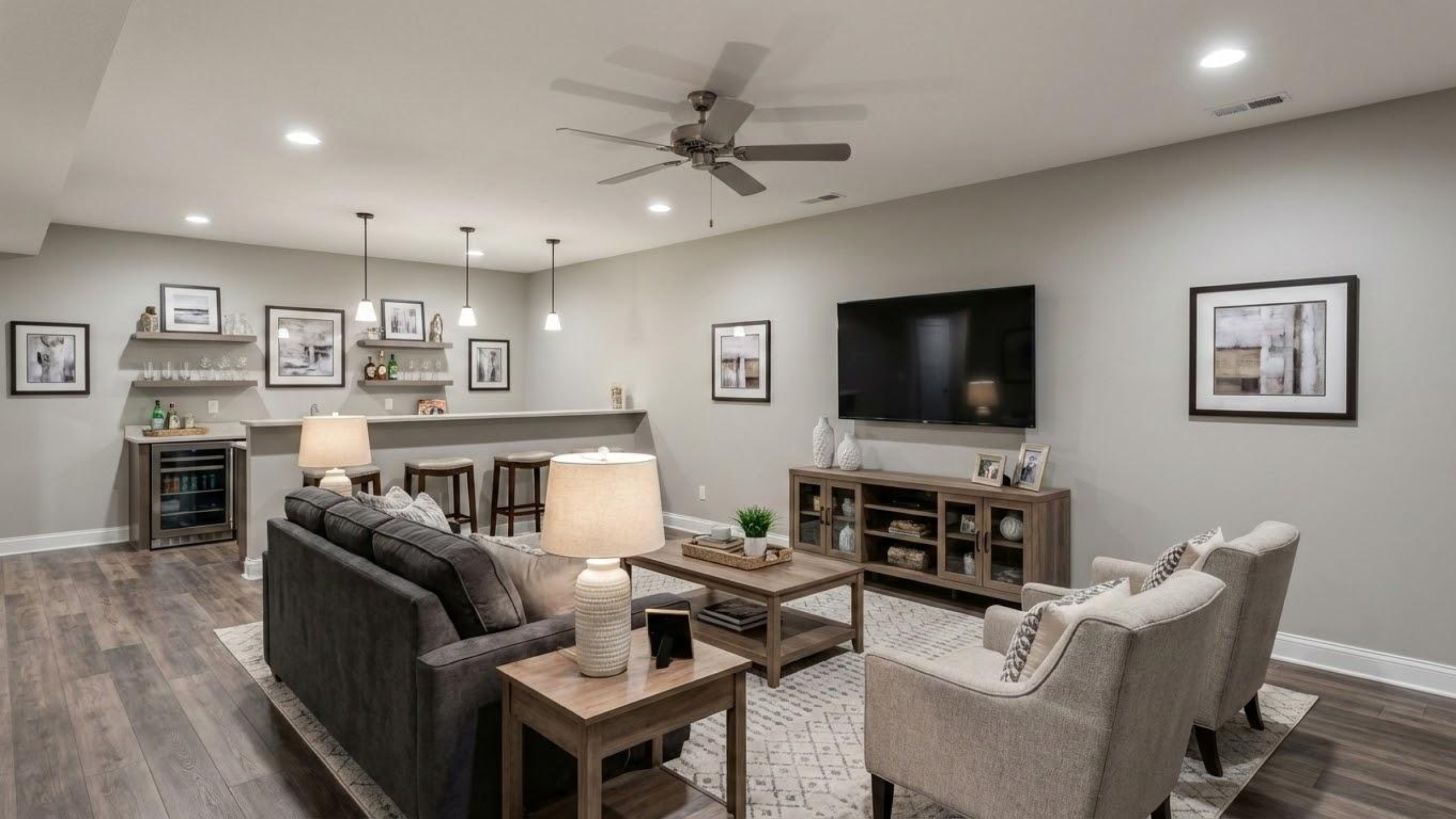 A professionally designed finished basement in Mainline, PA, featuring a custom wet bar, modern living area, and open-concept layout.