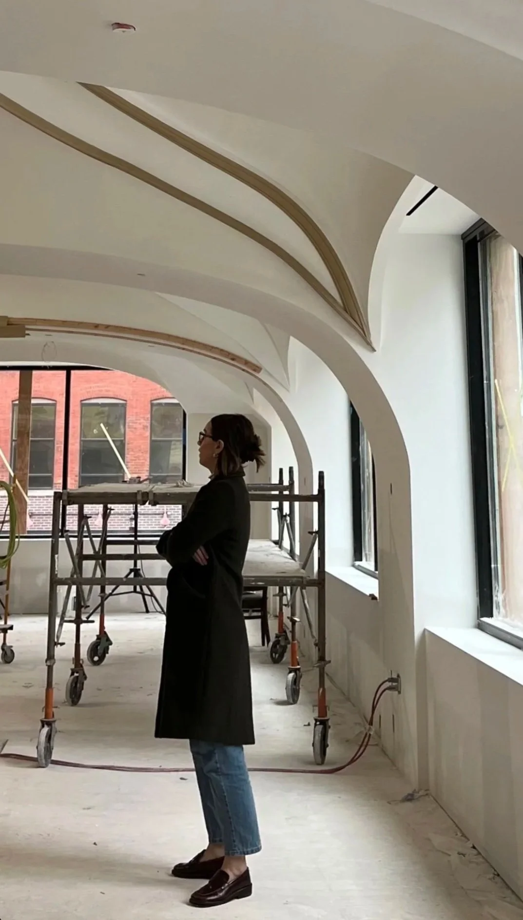 Interior Designer Jamie from In Between the Detail looking at room in production.