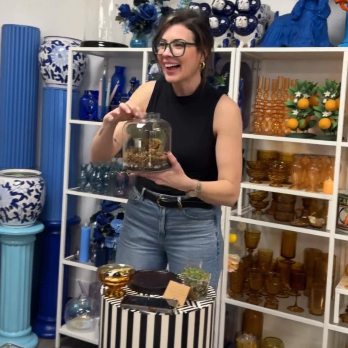 Lauren, founder of Lauren and Plants, holding a completed begonia terrarium while hosting a creative, grounding terrarium workshop in Irving, Texas.