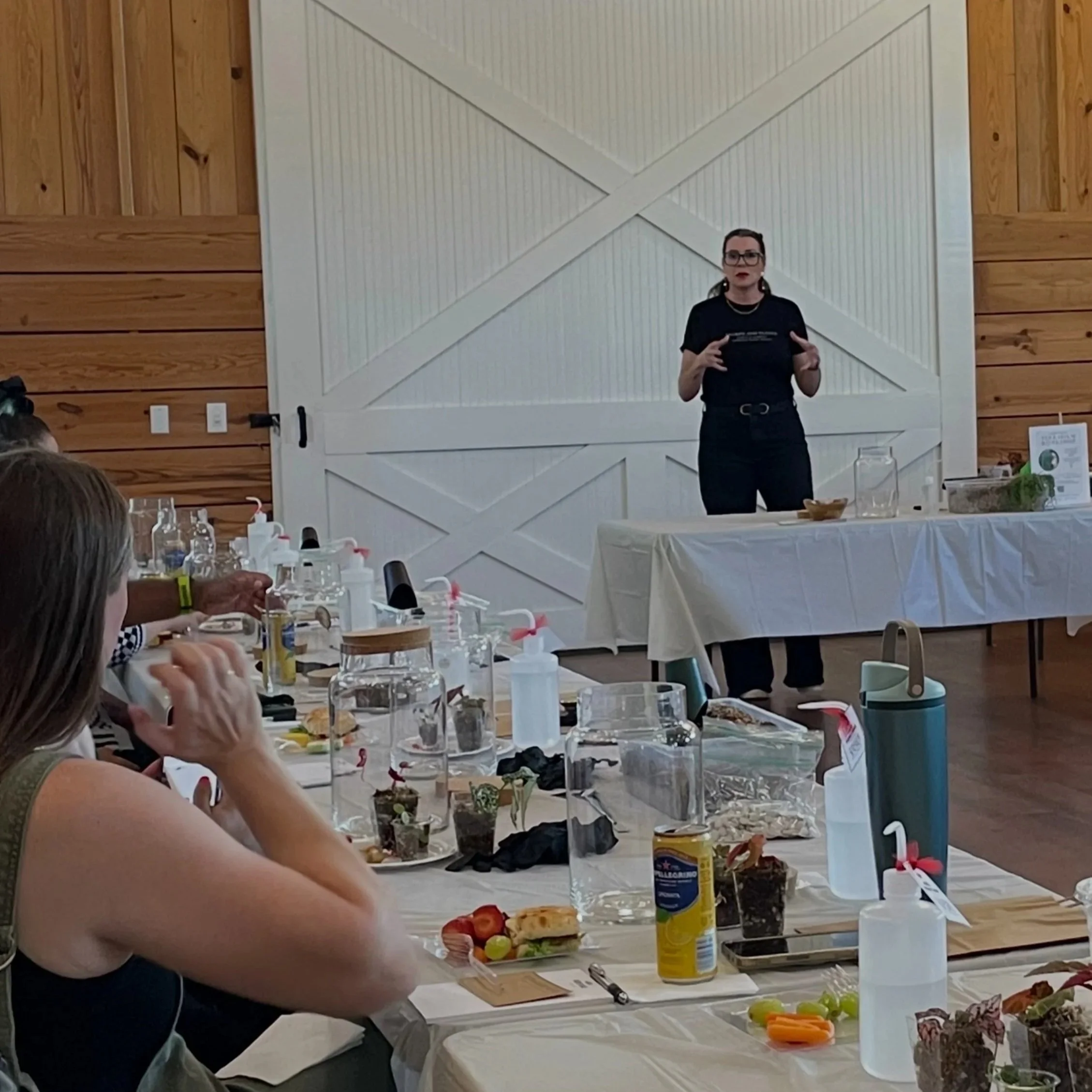 Lauren from Lauren and Plants leading a hands-on corporate plant workshop for employees during a team-building event in Fort Worth, Texas.