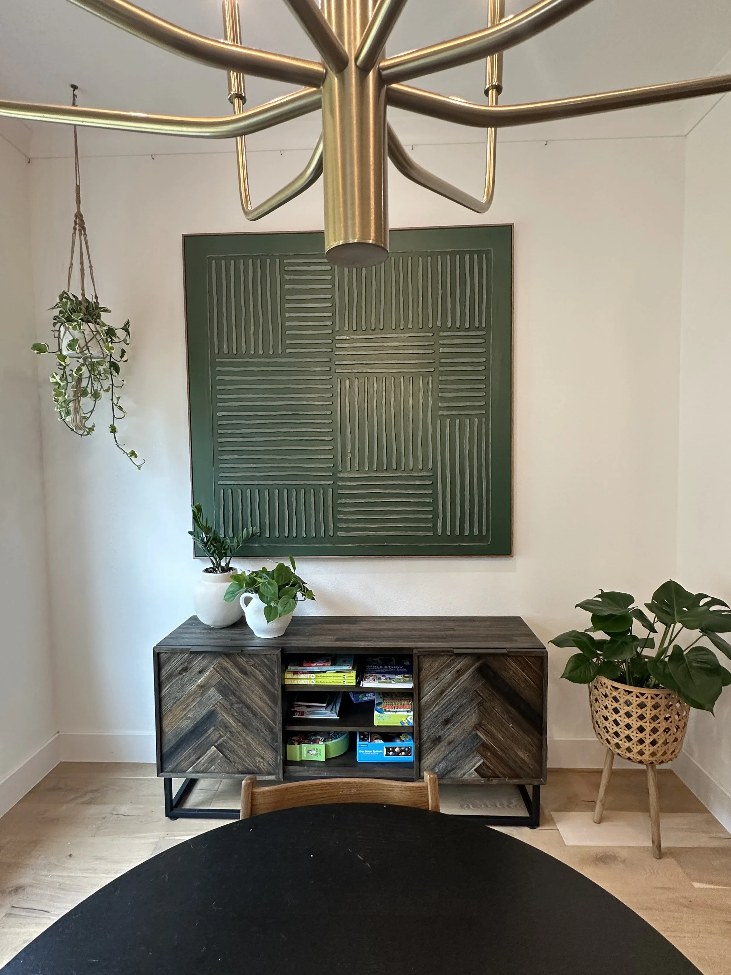 Dining room plant styling in Fort Worth featuring a monstera and curated greenery in a modern, balanced space