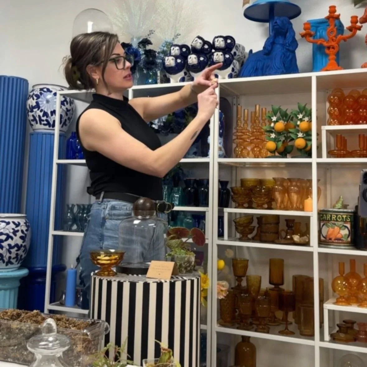 Lauren demonstrating plant placement and terrarium design techniques during a guided terrarium workshop at The Floral Eclectic Studio.