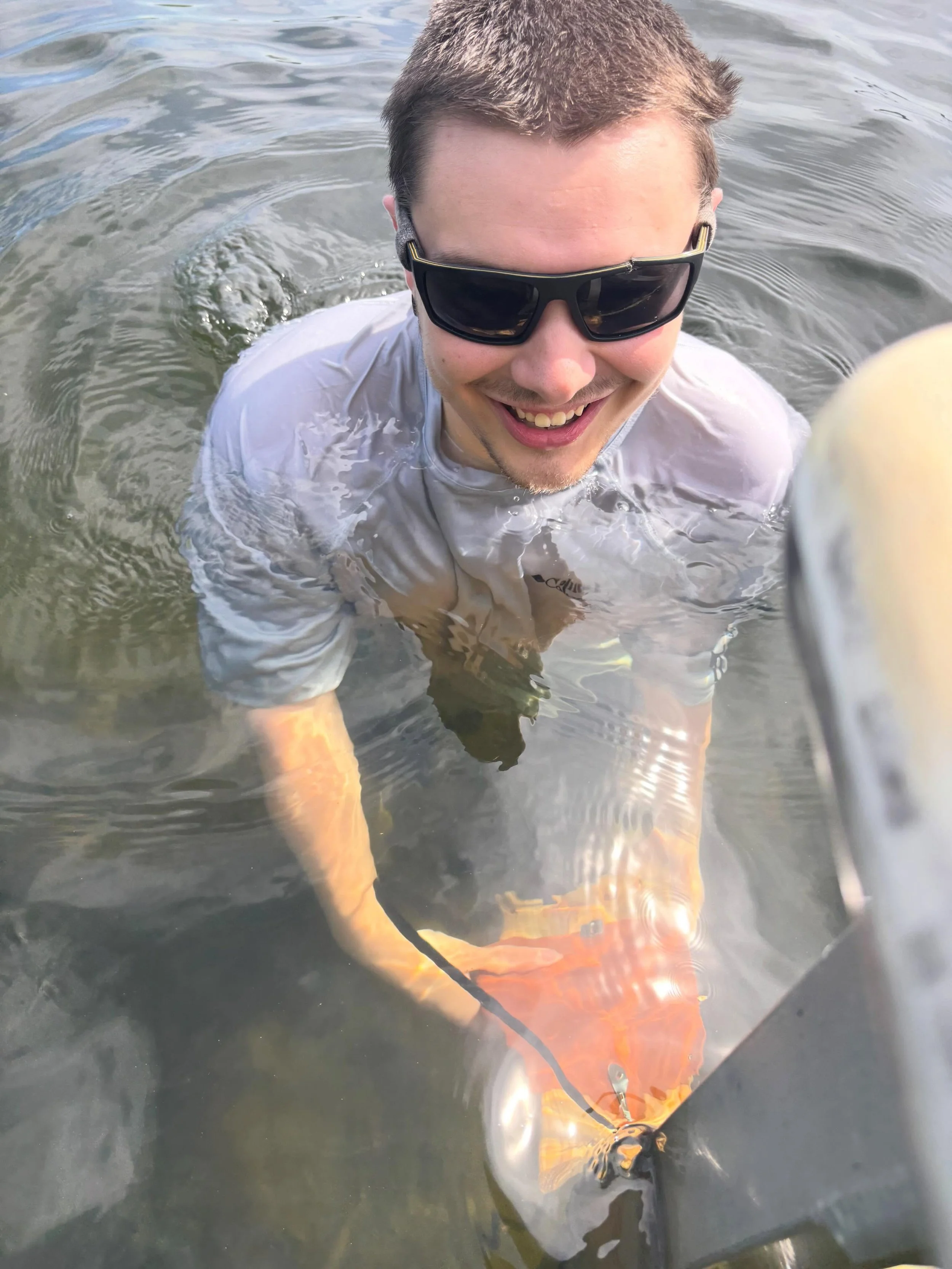 Trevor installing tiles on volunteered docks today for our Shoreland Monitoring Program. Thanks Trevor for braving the cold water.  The tiles will be retrieved in early September for algae analysis.
