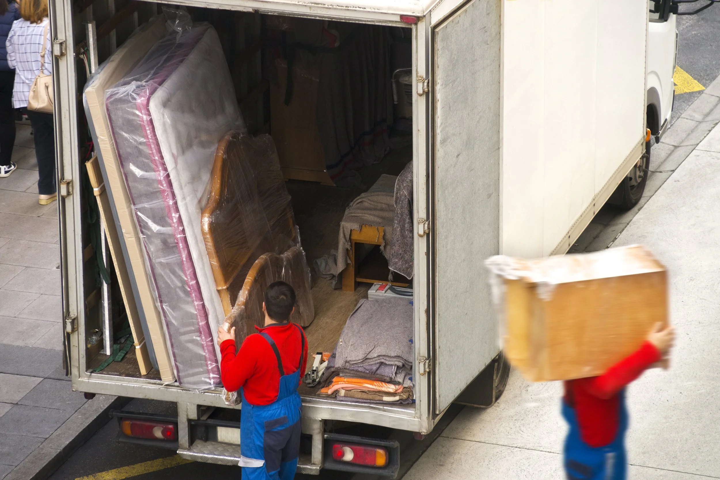 high-angle-view-delivery-men-working-by-truck-road.jpg