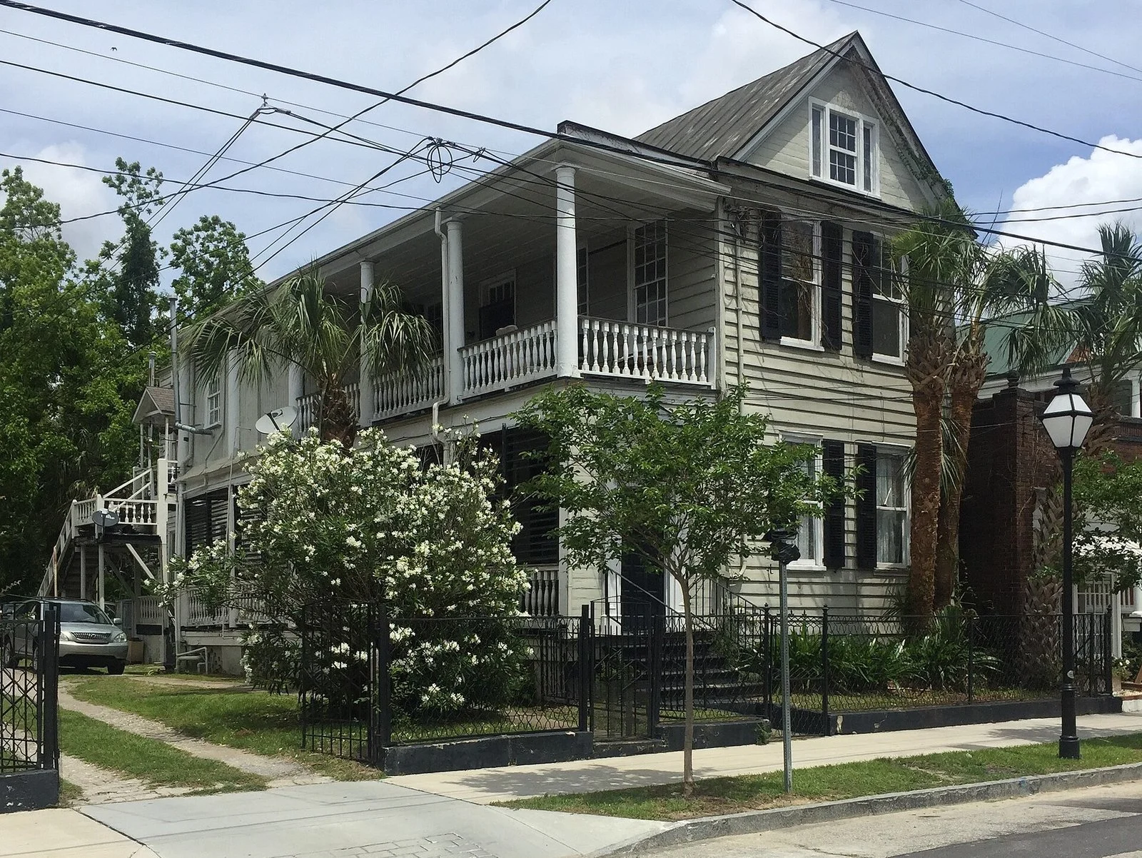 Wood Charleston single house with double piazzas and an iron fence on Cannon Street, Charleston SC