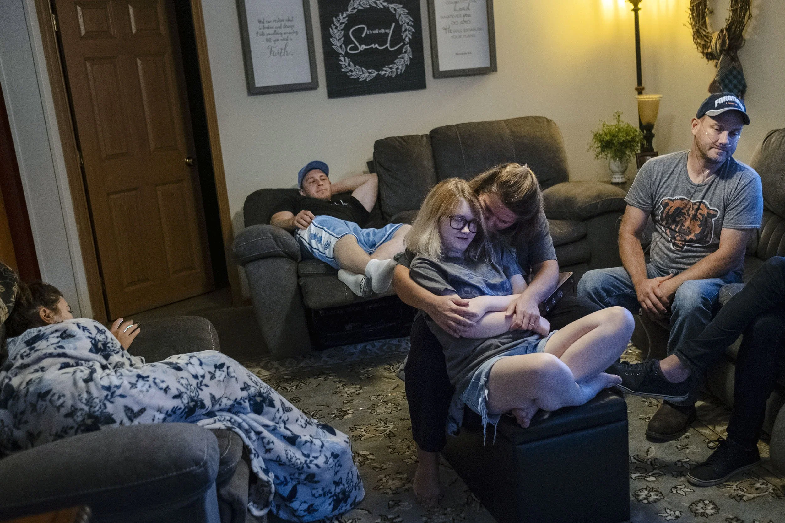 Glenn together with his wife, two daughters, son-in-law and visitor in their living room in Sookeys Creek, Kentucky. 