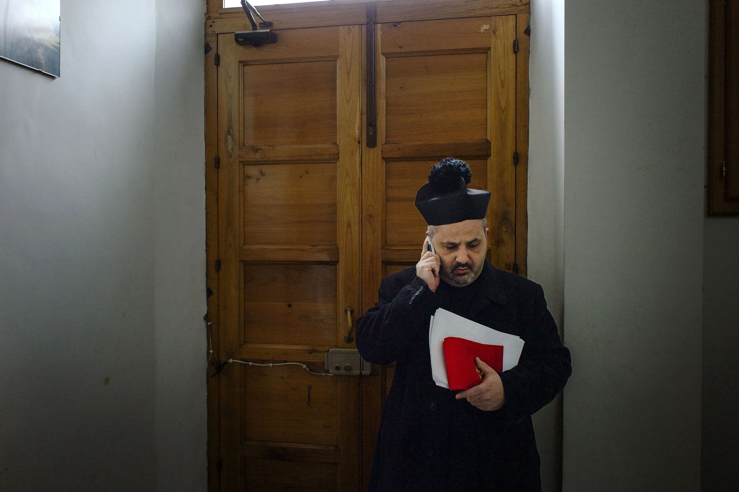 A priest busy organising the processions in Randazzo, Sicily.
