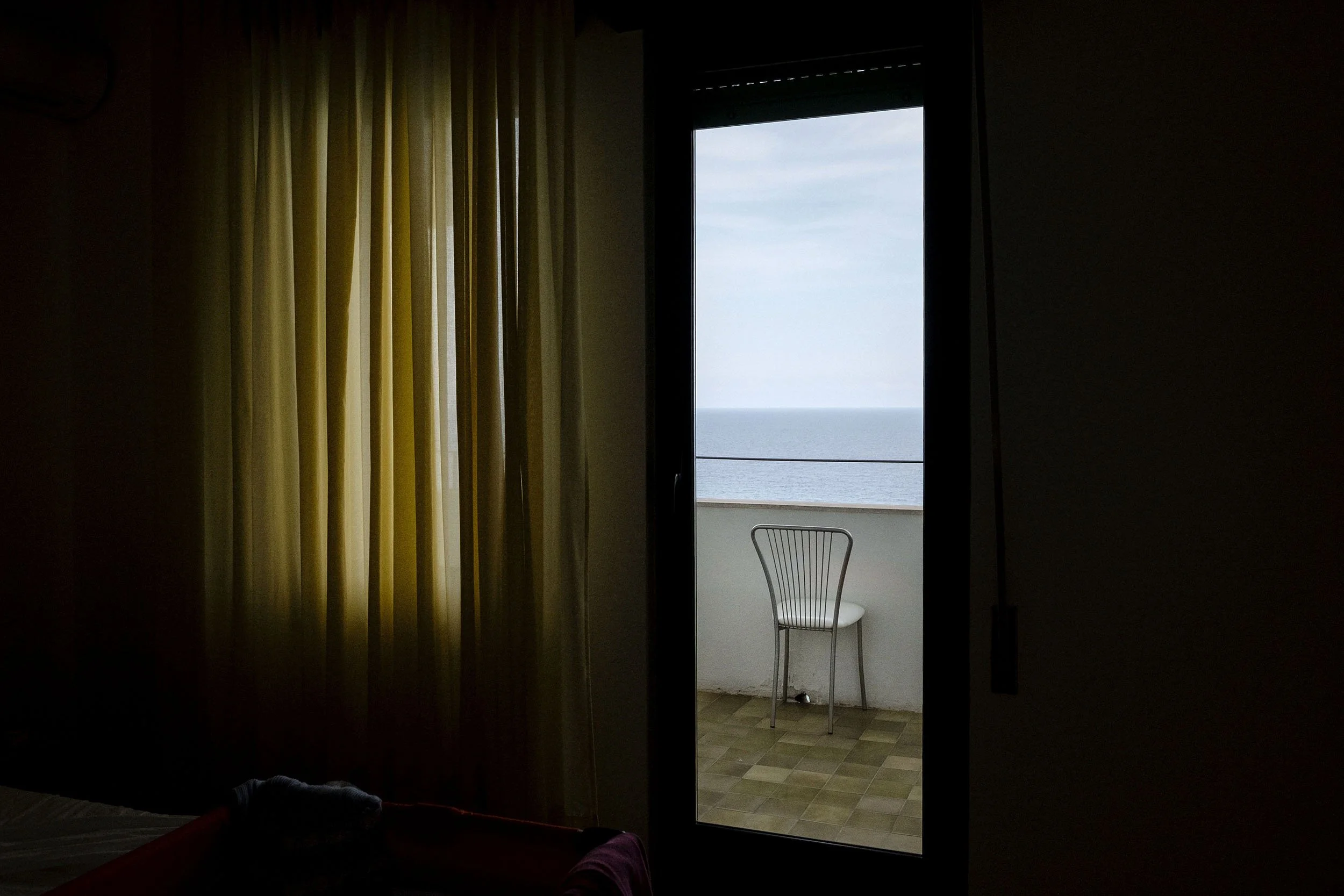 A chair on a balcony in a apartment, Gioiosa Marea, Sicily.