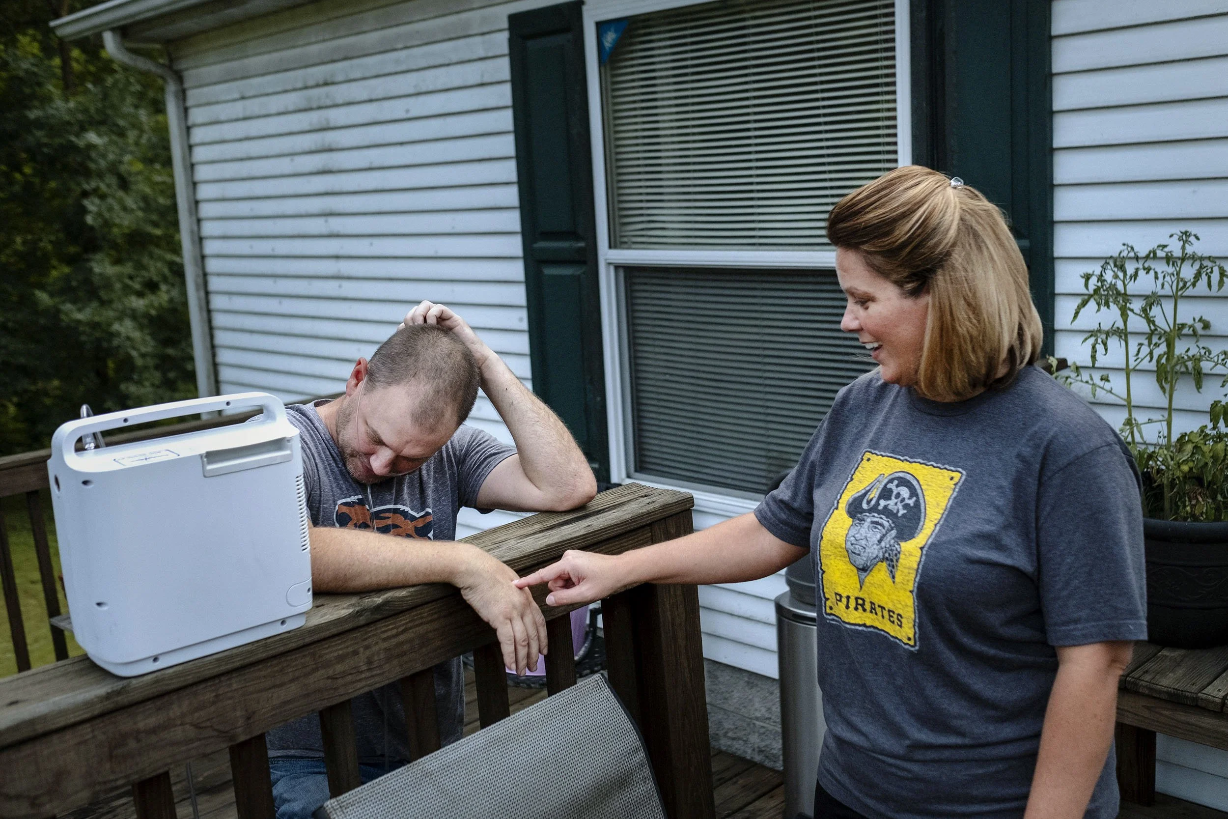 Glenn receives a little comfort from his wife while trying to BBQ scallops. Sookeys Creek, Kentucky.
