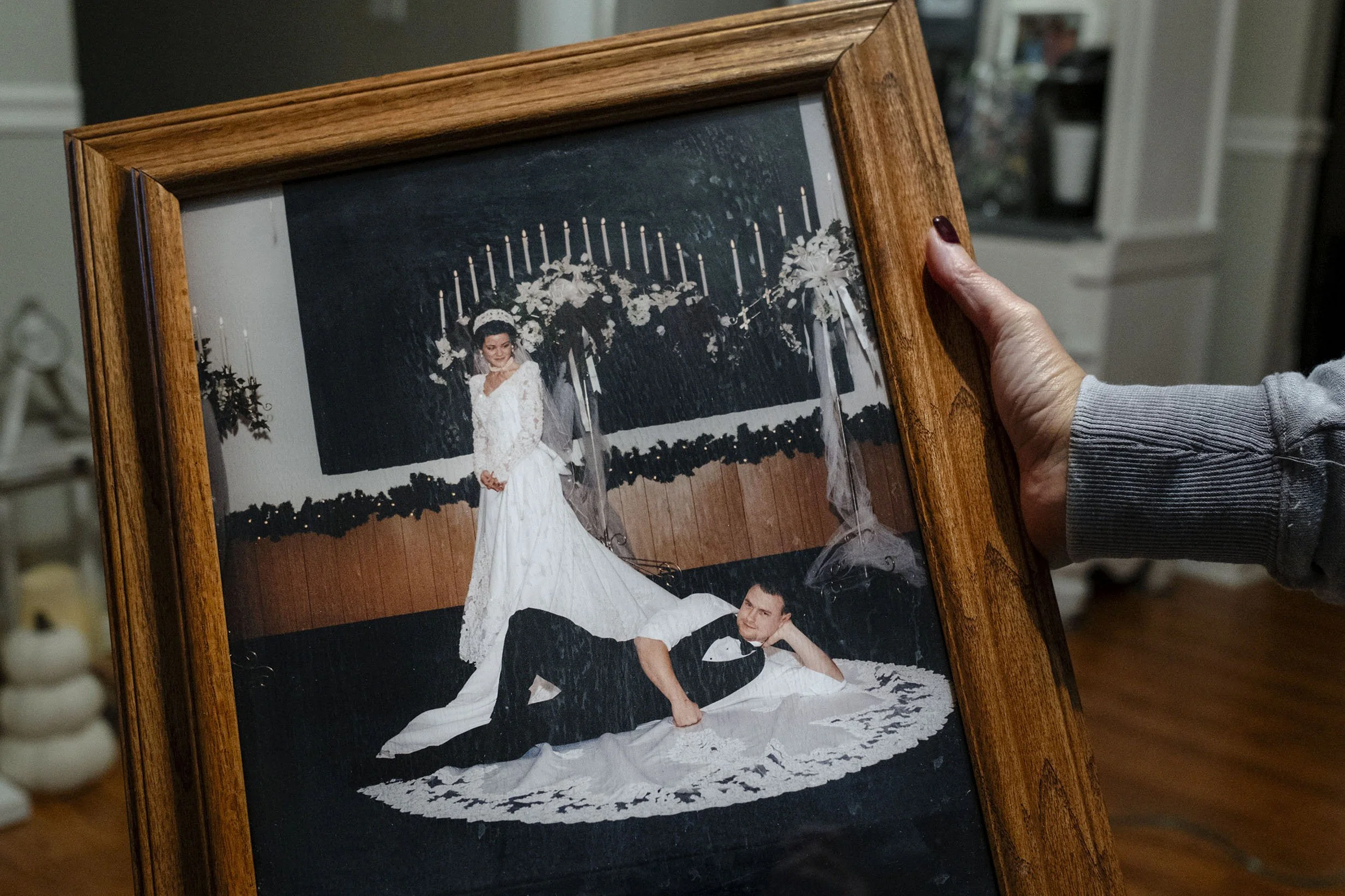 Glenn shows his wedding photograph. Robinson Creek, Kentucky.