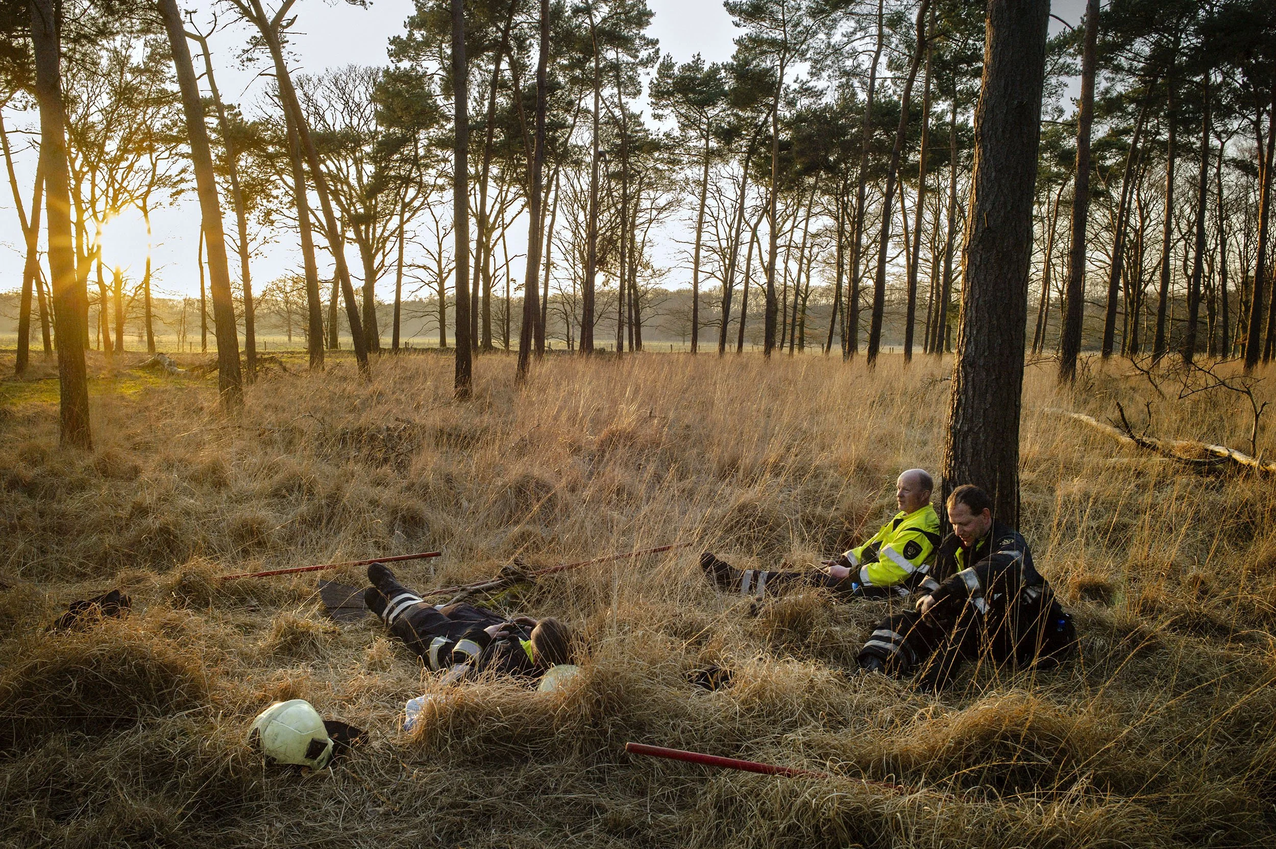 Firefighters rest after battling a massive dune fire for hours in Loon op Zand, the Netherlands.