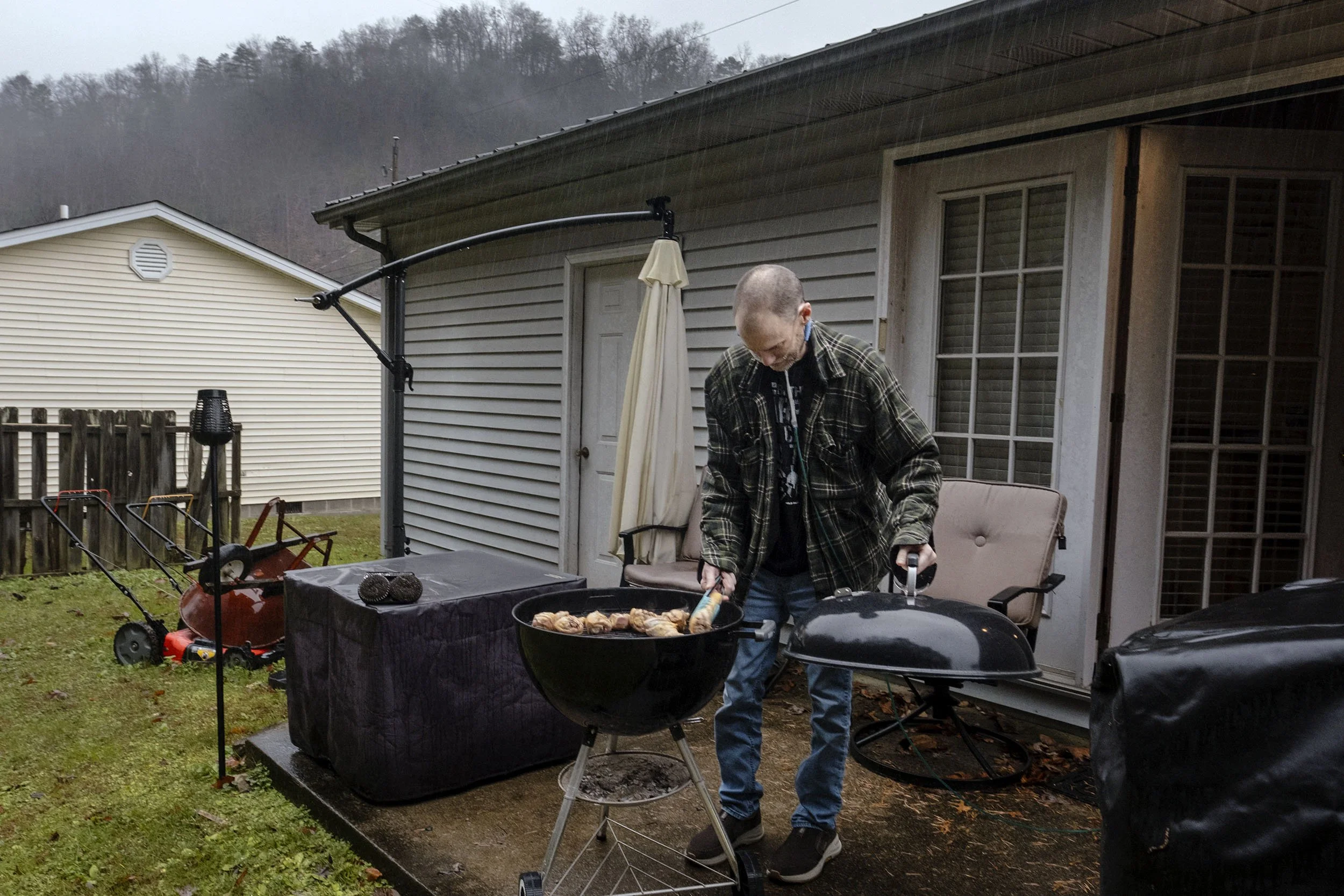 Glenn slow BBQing chicken for 3 hours in his back yard, Robinson Creek, Kentucky. 