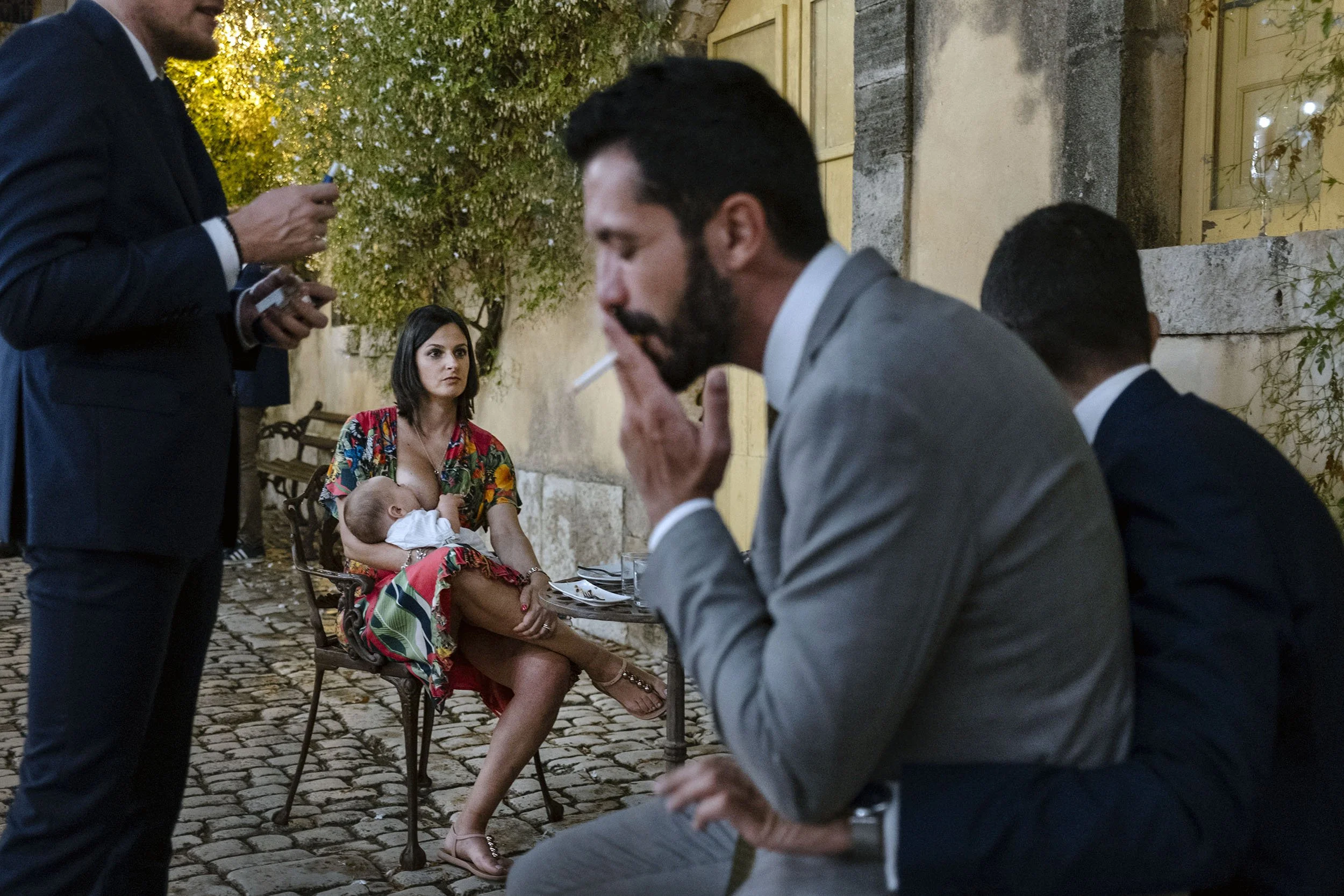 A mother breastfeeds her baby surrounded by friends during a gay wedding in Chiaramonte, Sicily.