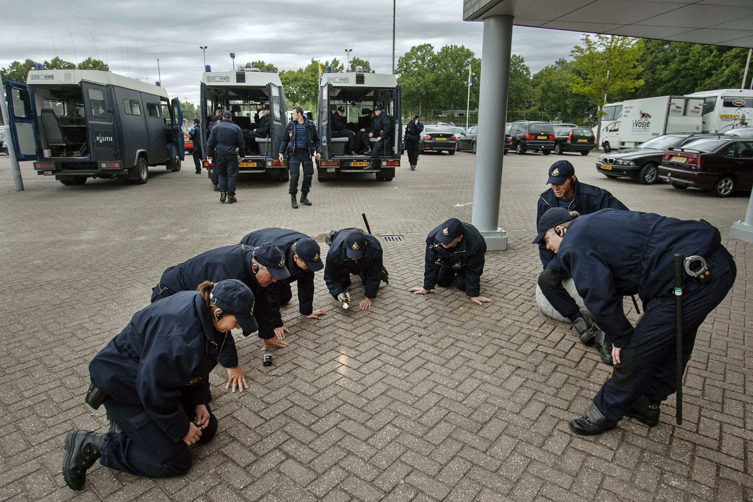 Riot police search for a contact lens at the RKC-FC Dordrecht game in Waalwijk, the Netherlands.