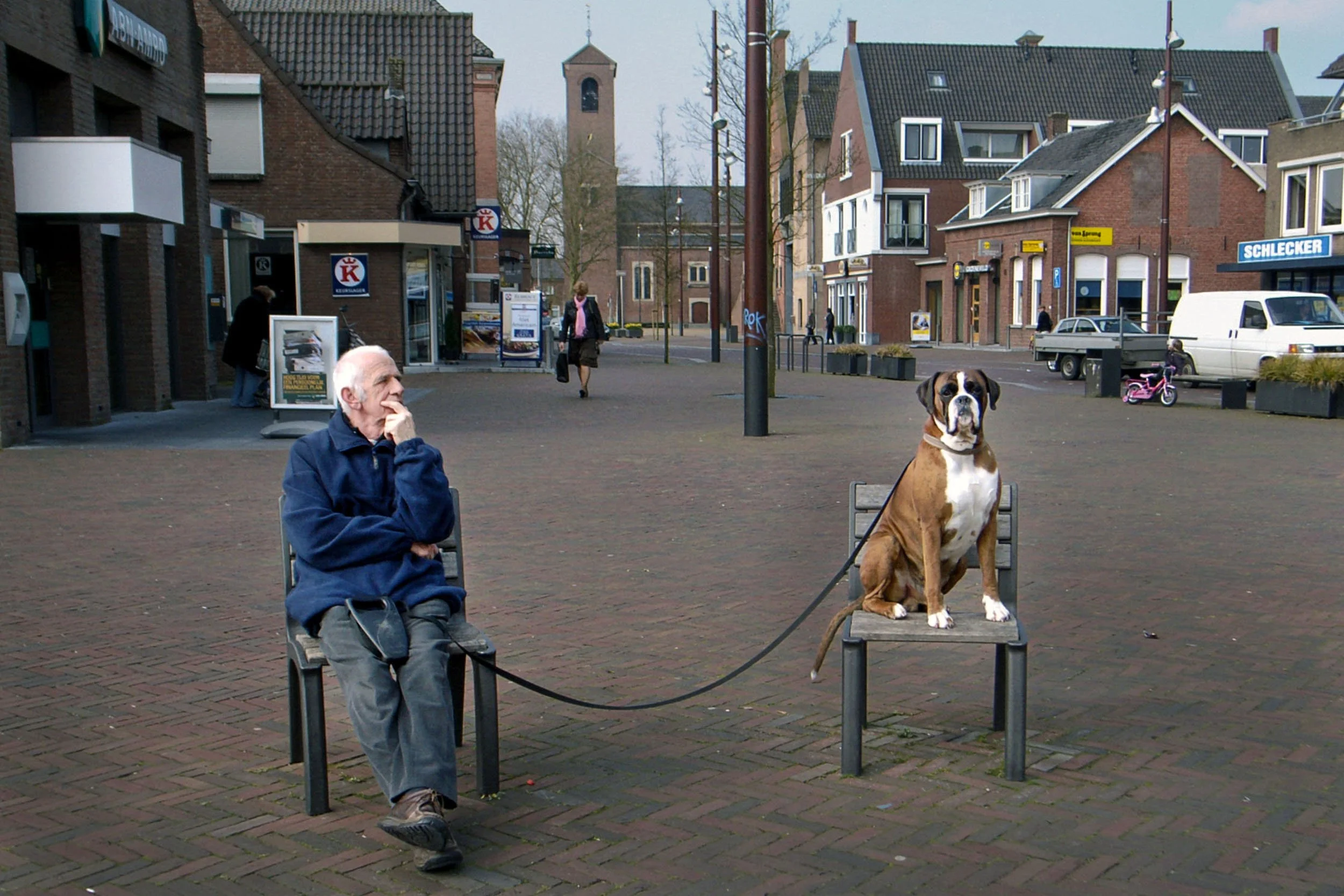 A dog and its owner sit on benches in Drunen, the Netherlands.