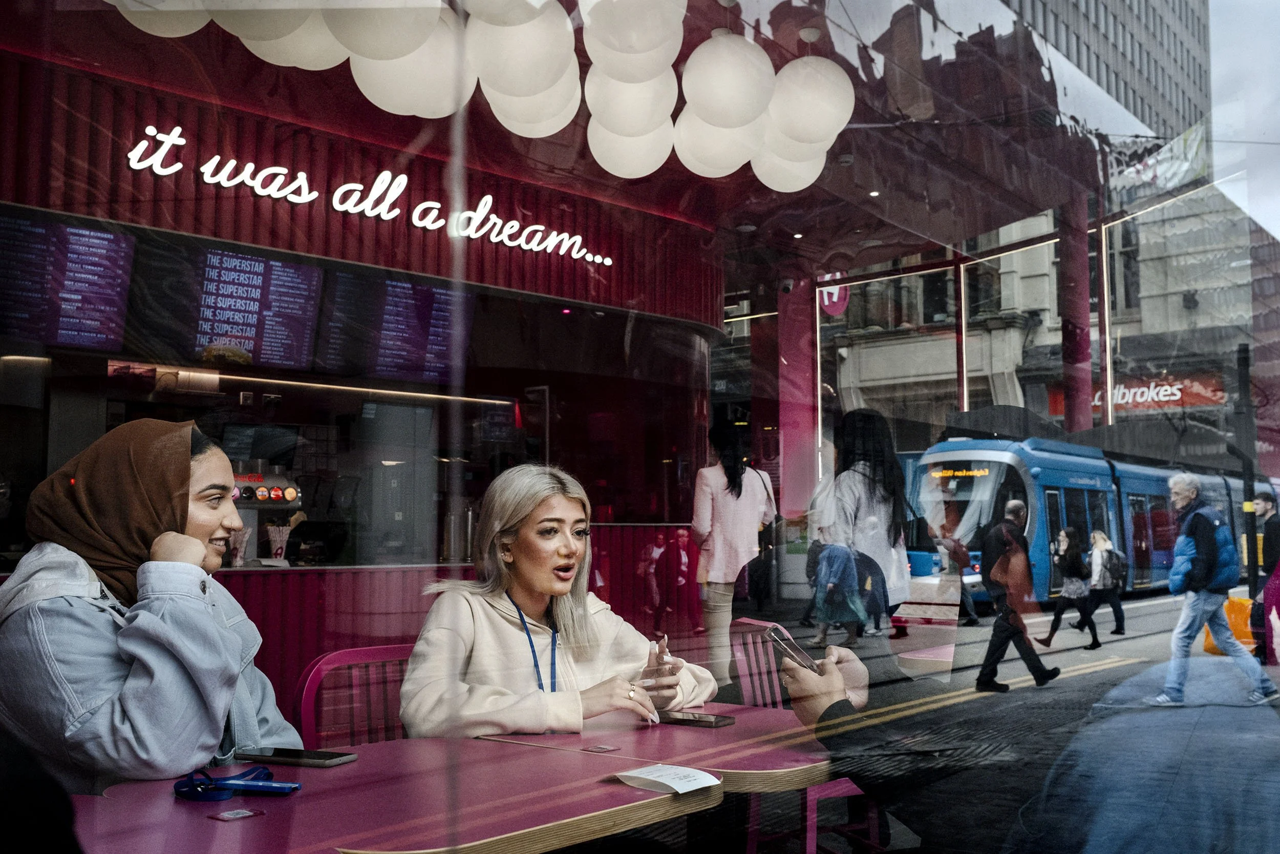 A reflection of in the window of Archie’s Burgers in Birmingham, England.