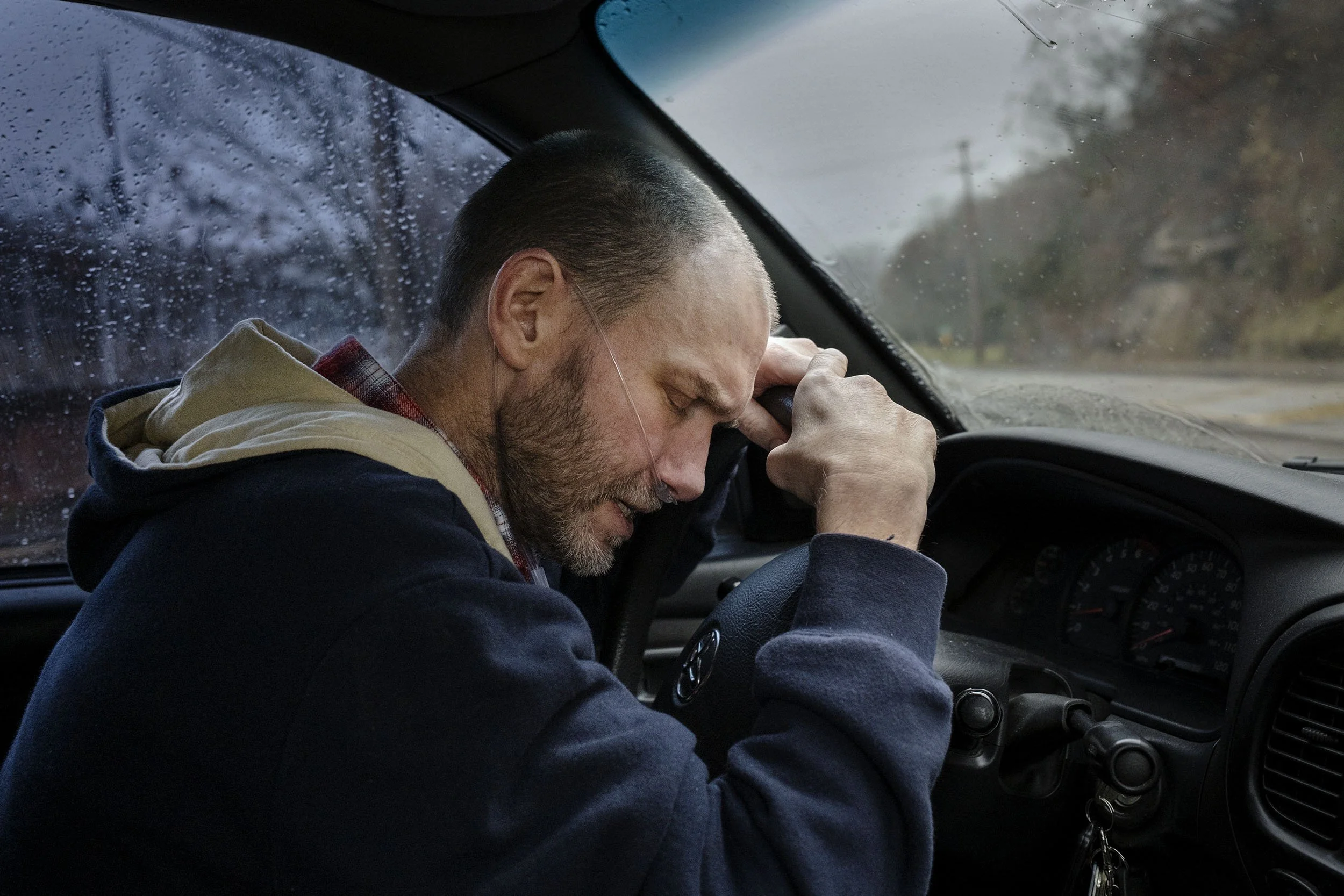 Glenn is really starting to suffer the effects of not being able to breathe and has to stop driving until the pain eases a bit. Virgie, Kentucky. 