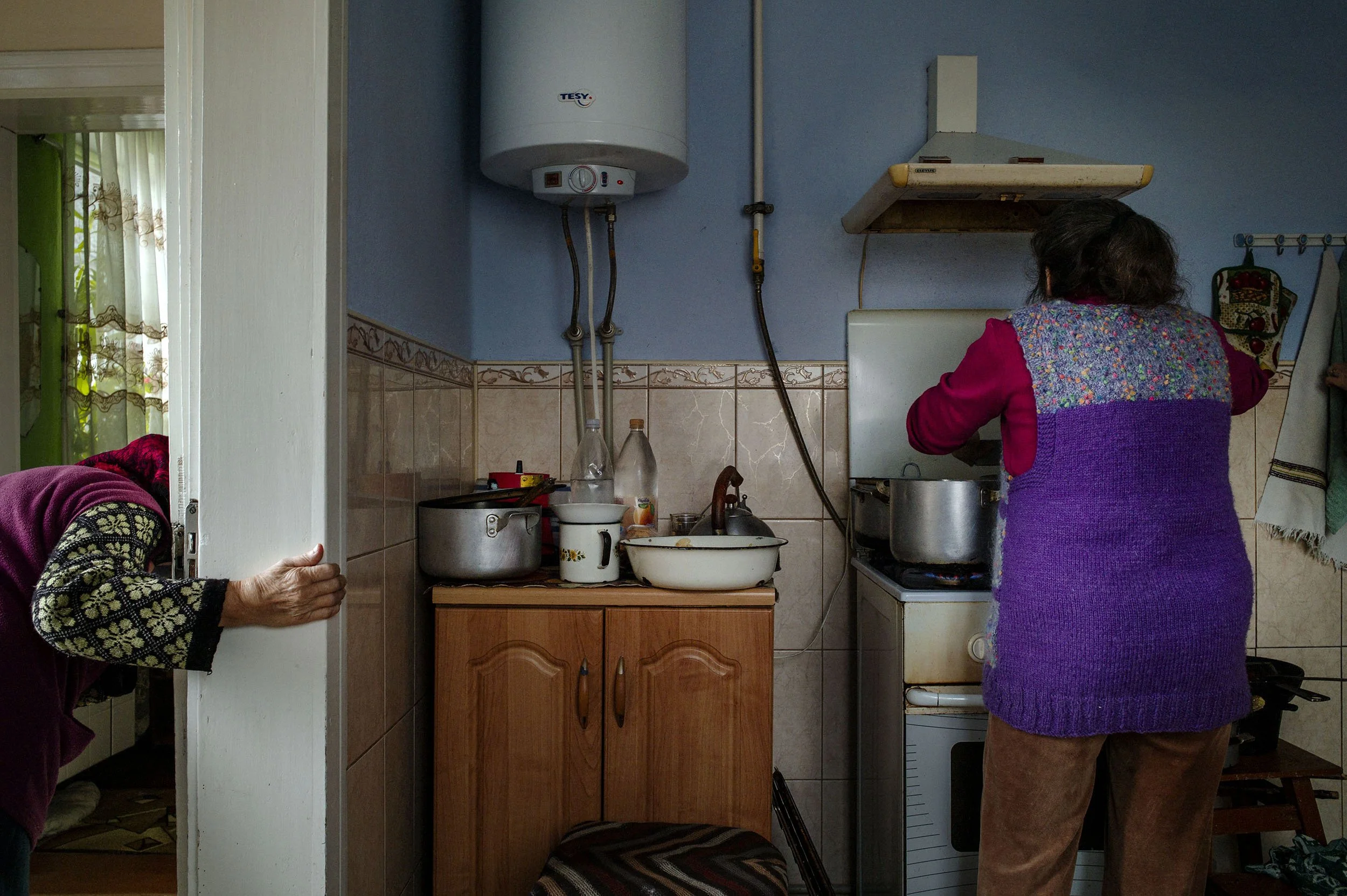 A grandmother and great grandmother cook for the whole family. 