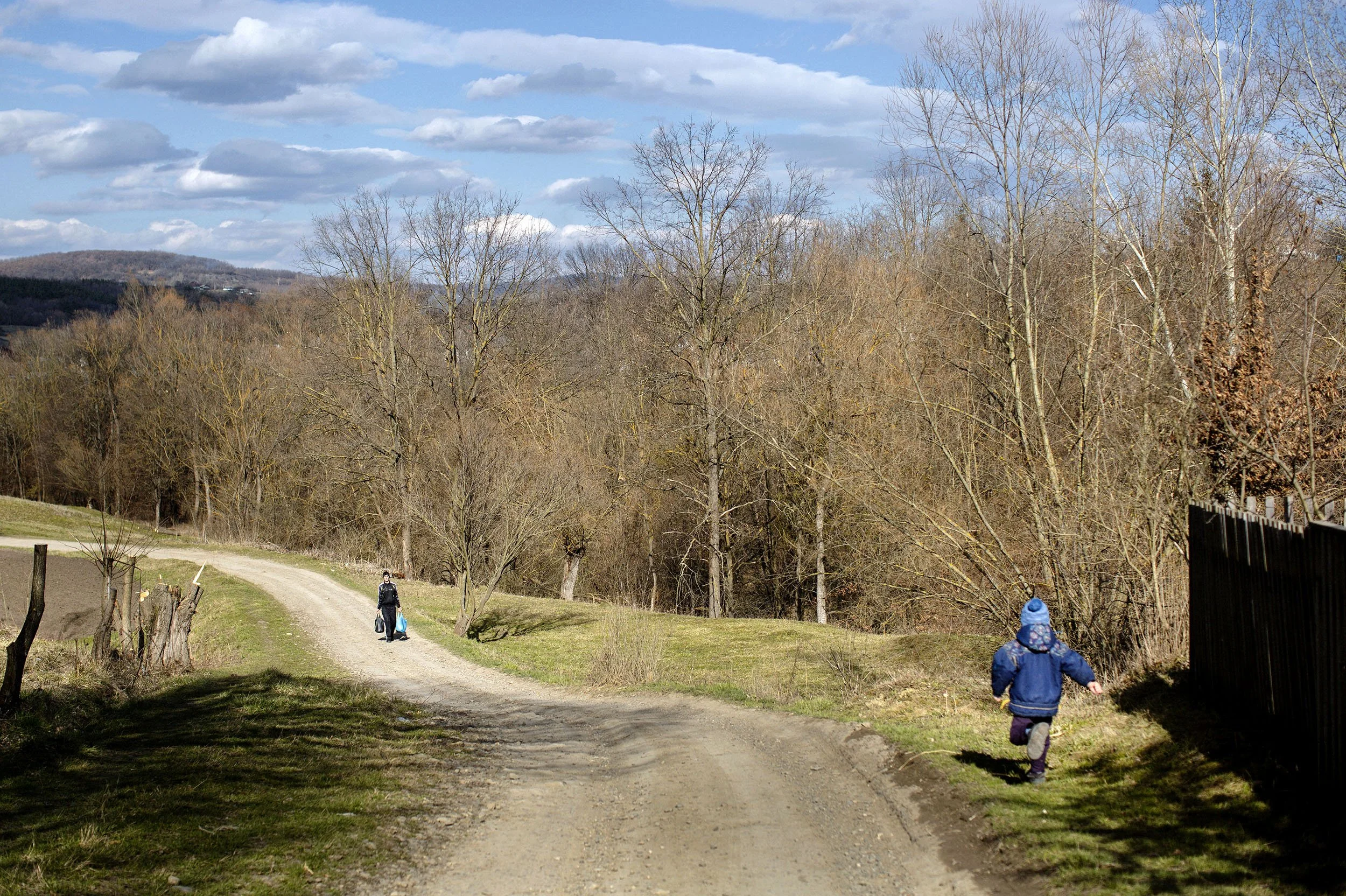 A child runs after his mother in the village of Bobivtsi.