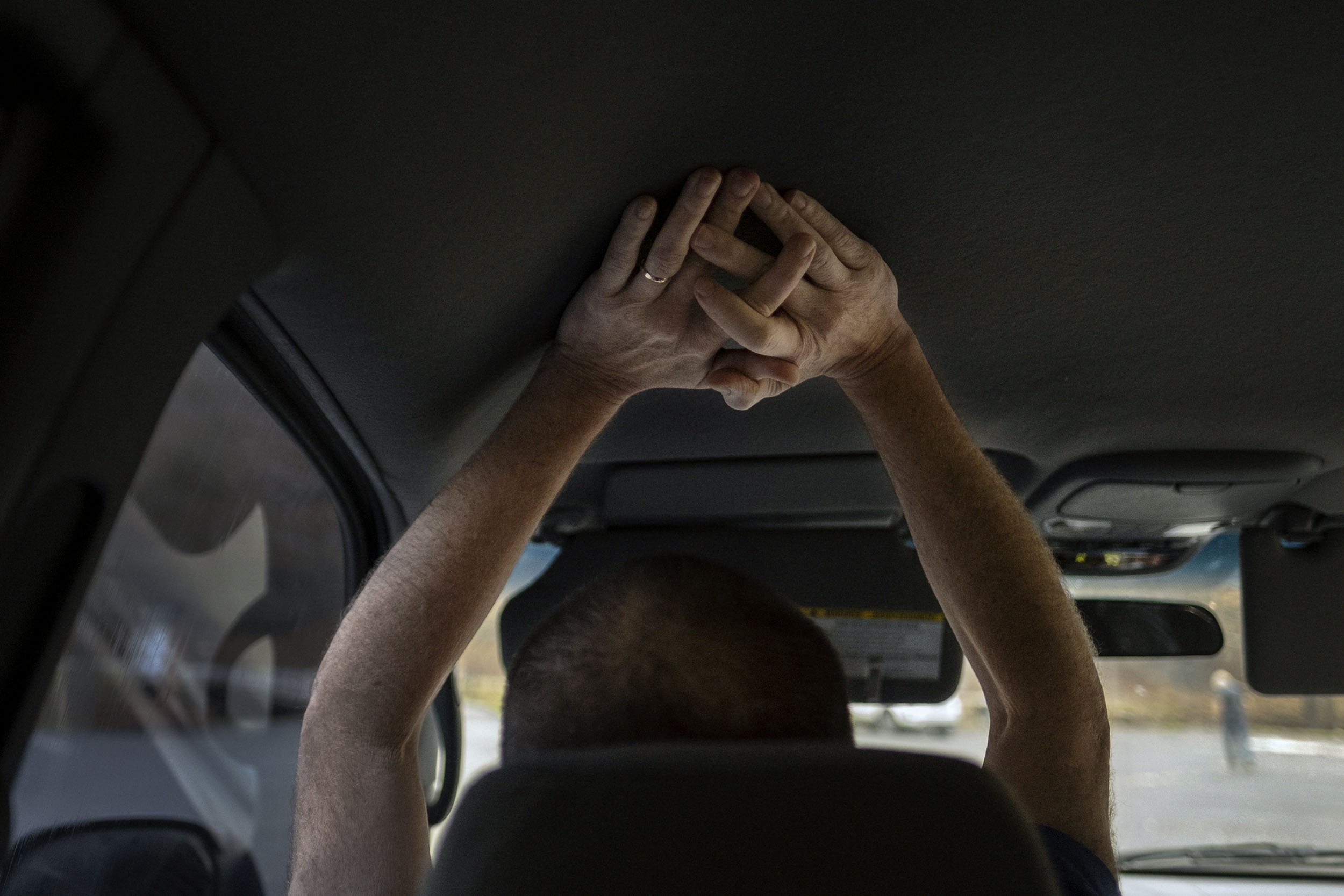 Glenn stops his truck to catch for breath and is in pain. Robinson Creek, Kentucky. 