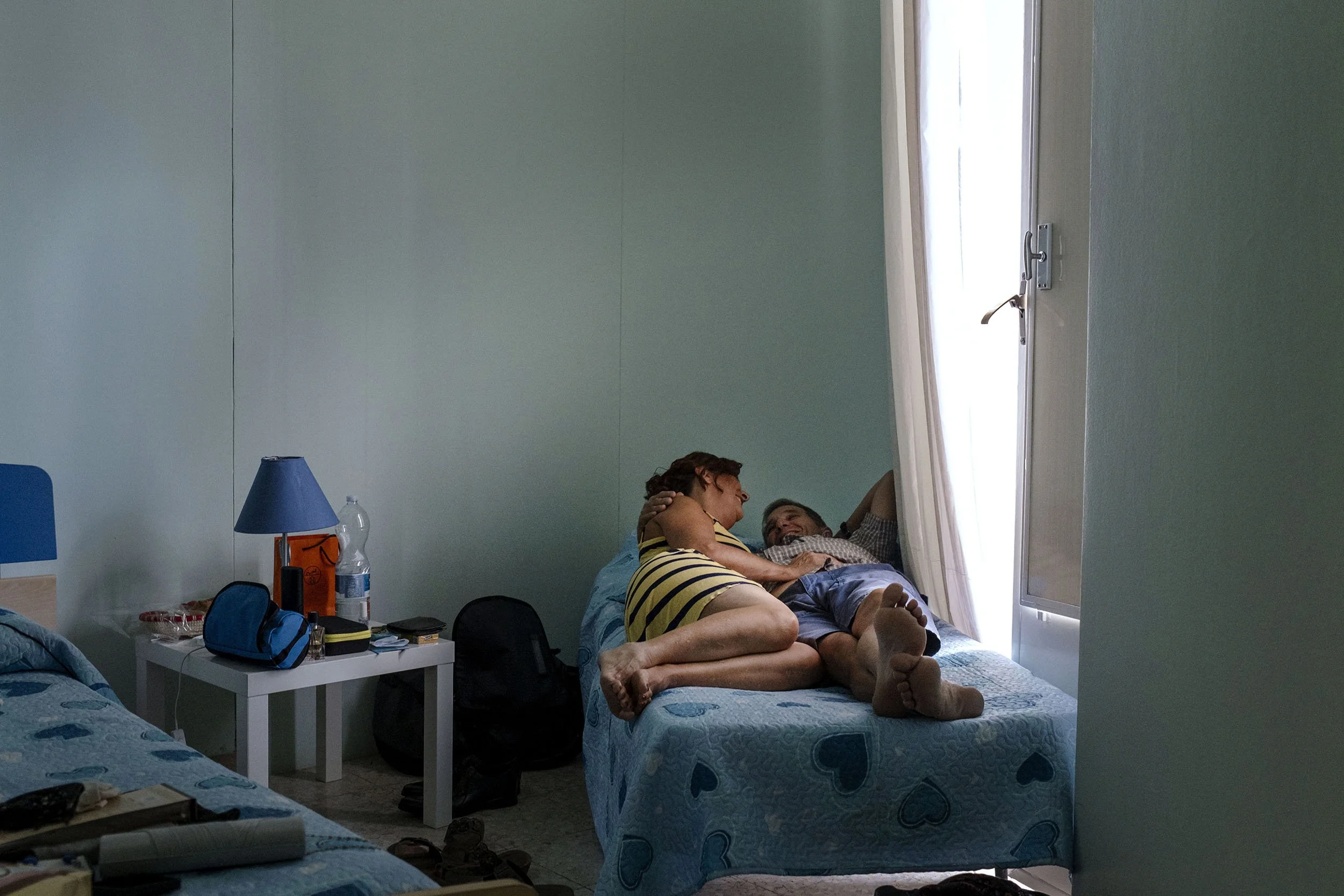 Parents of one of the two grooms take a little rest before the ceremony, Chiaramonte, Sicily.