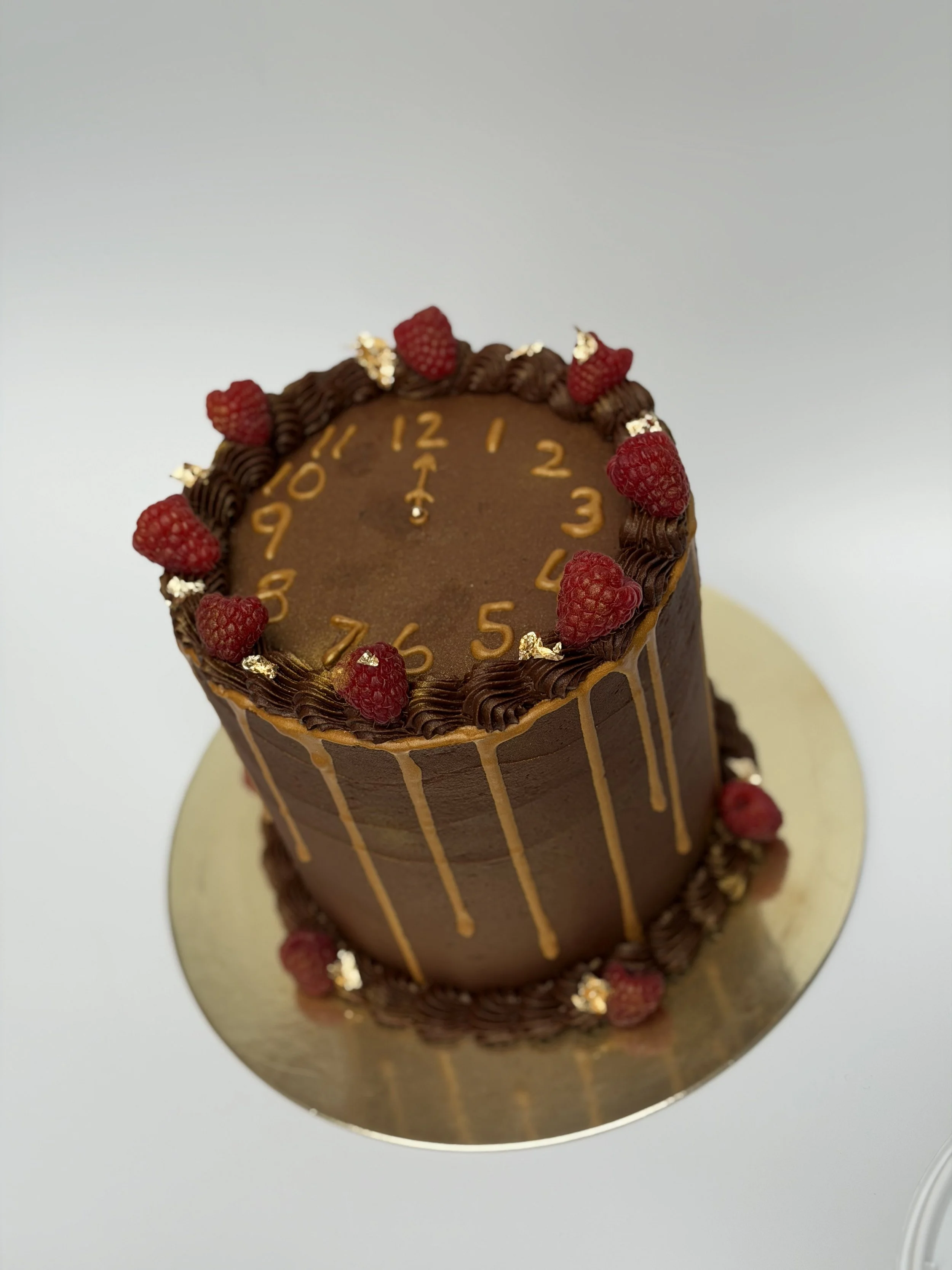 Vanilla cake with chocolate ganache and raspberry jam filling and chocolate buttercream