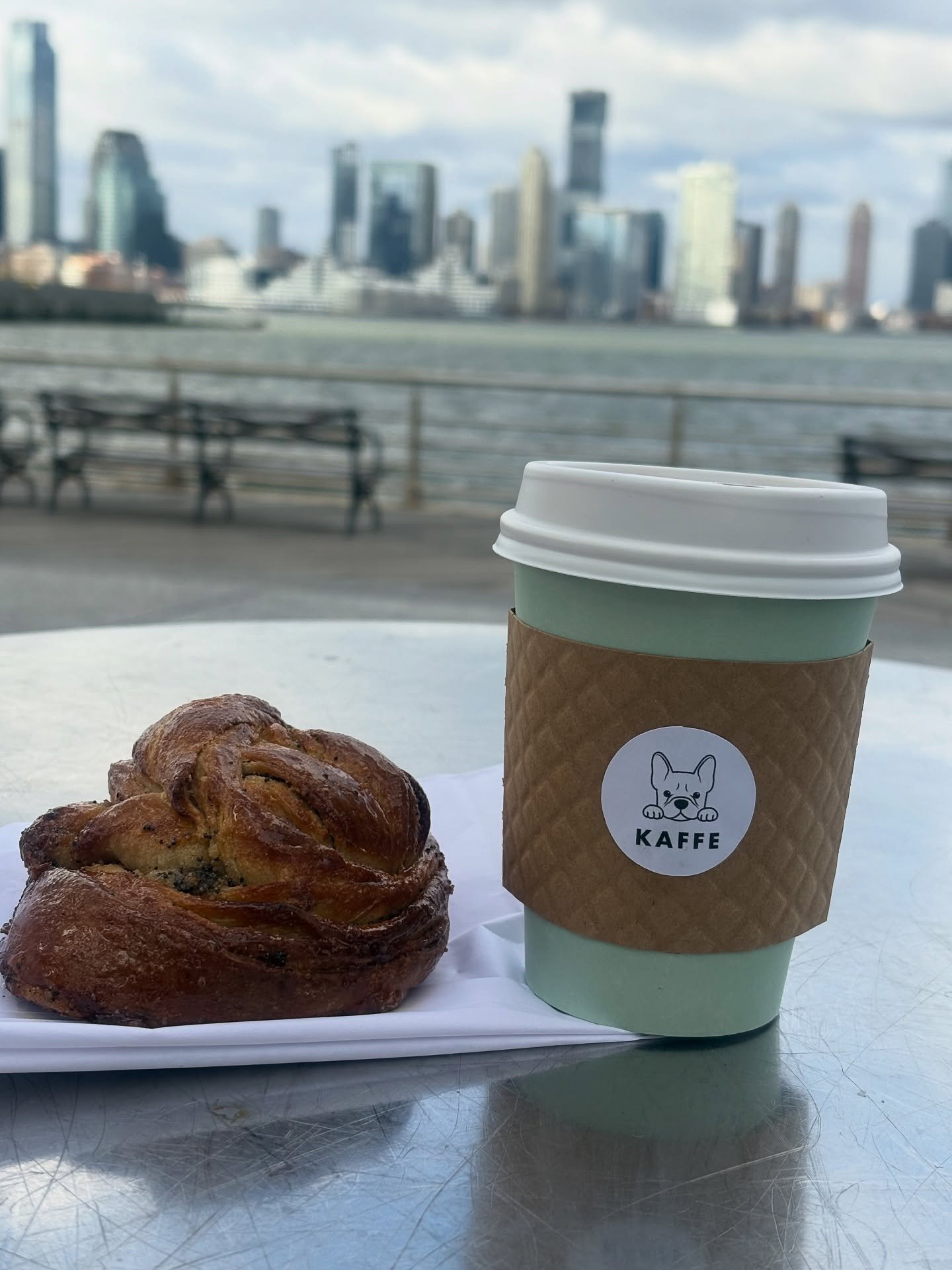 A calm moment by the water 
Cardamom bun, city skyline, and a little Kaffe magic. #FikaTime #KaffeNYC #WestVillage #GreenwichVillage #SwedishCoffeeMoments #winter #coffee