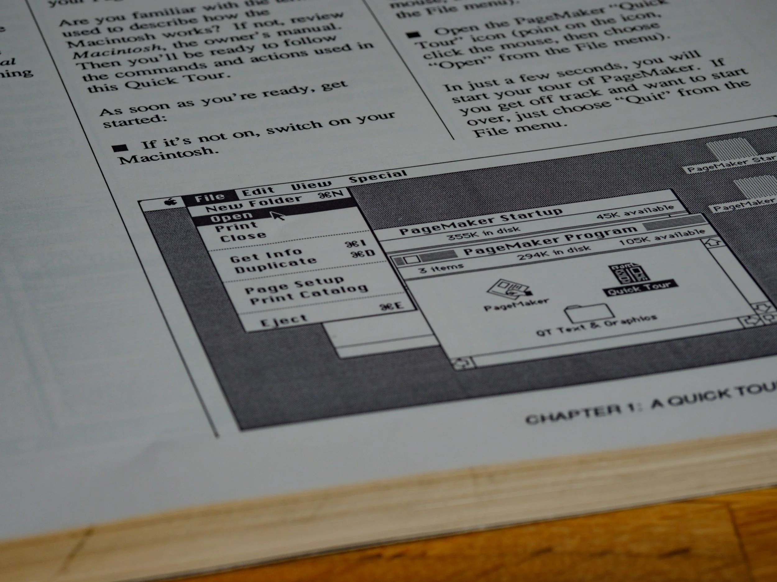 A black-and-white computer screen diagram showing a menu for a vintage Mac computer, with options like 'Open,' 'Print,' 'Close,' and a window titled 'PageMaker Startup' with icons and text.