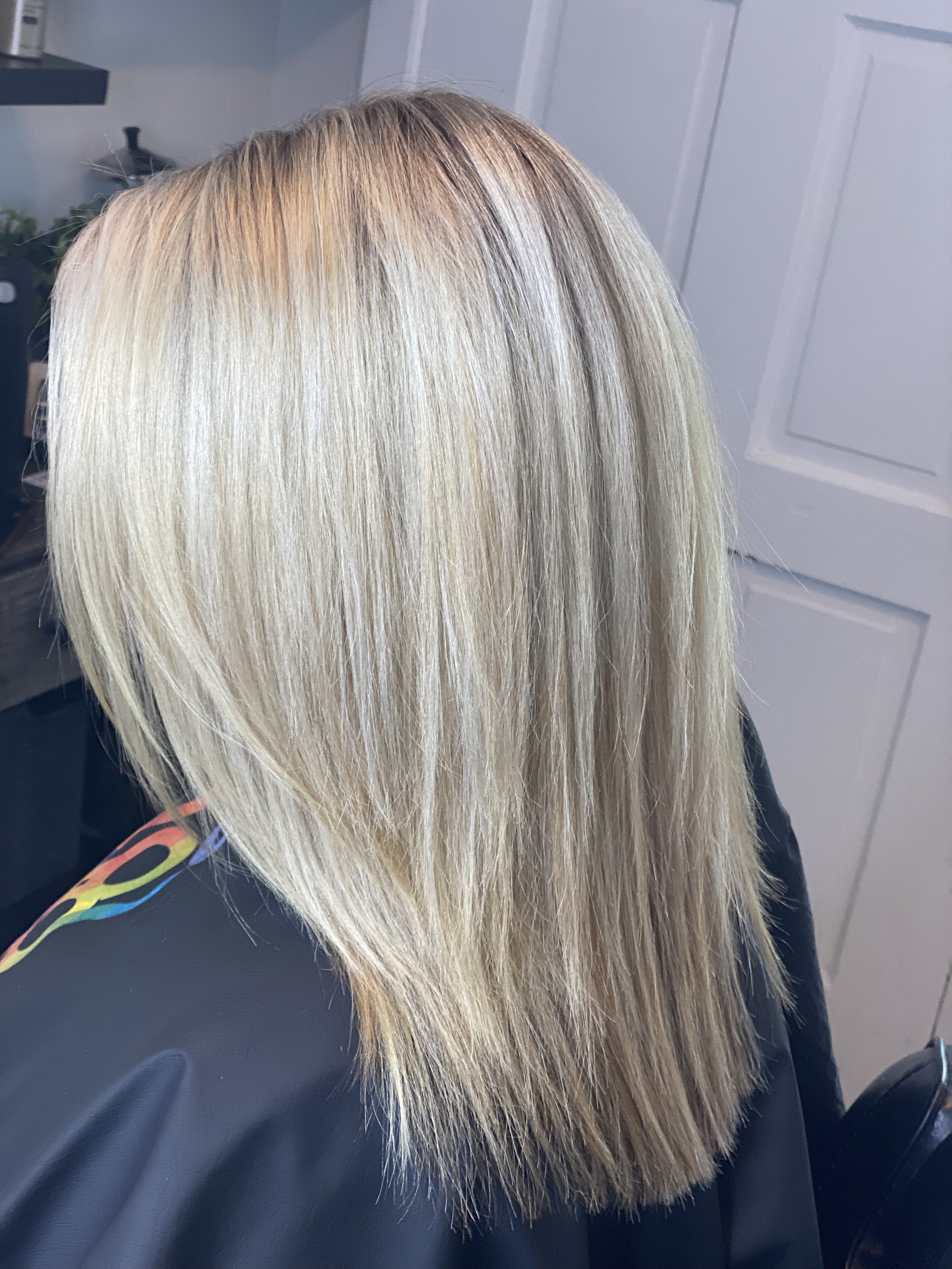 Blonde, straight, layered hair in a hair salon.