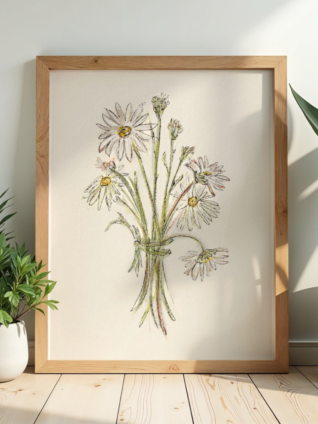 A framed watercolor or colored pencil drawing of a bouquet of daisies in a glass jar, leaning against a white wall with sunlight and a plant nearby.