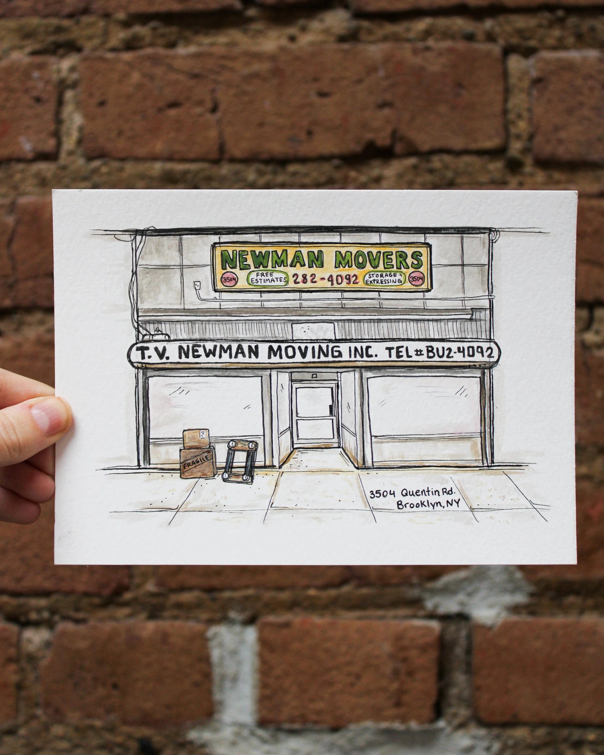 A hand holding a sketch of a storefront for 'Newman Movers' with signage displaying a phone number and address, in front of a brick wall.