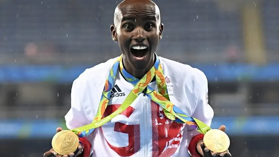 Mo Farah holding his medals at the Rio 2016 Olympics