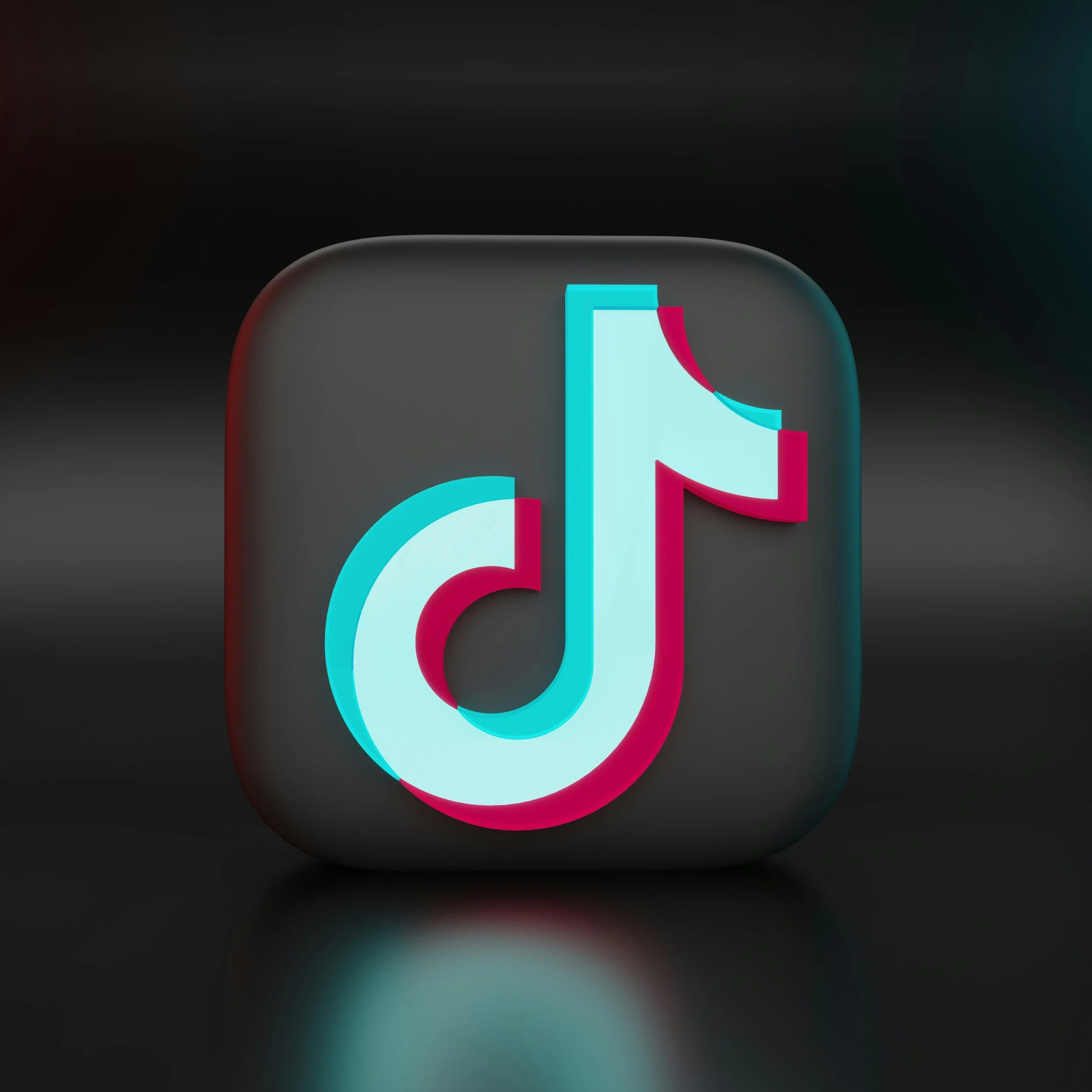 TikTok app icon, black background with rounded square shape and the white, pink, and cyan logo in the center.