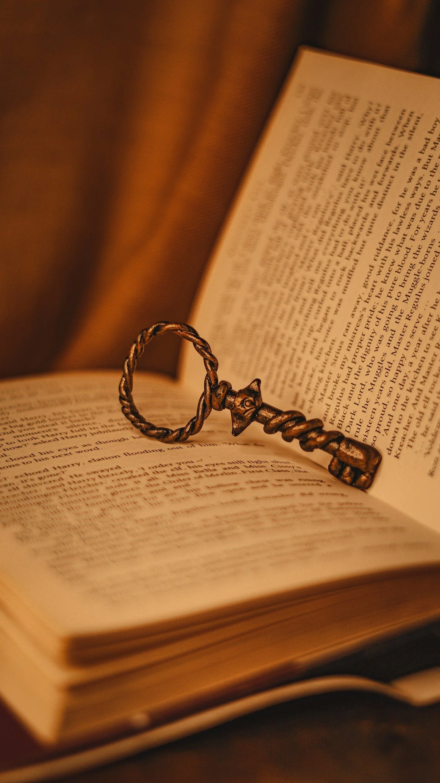 An antique key resting in the middle of a book.
