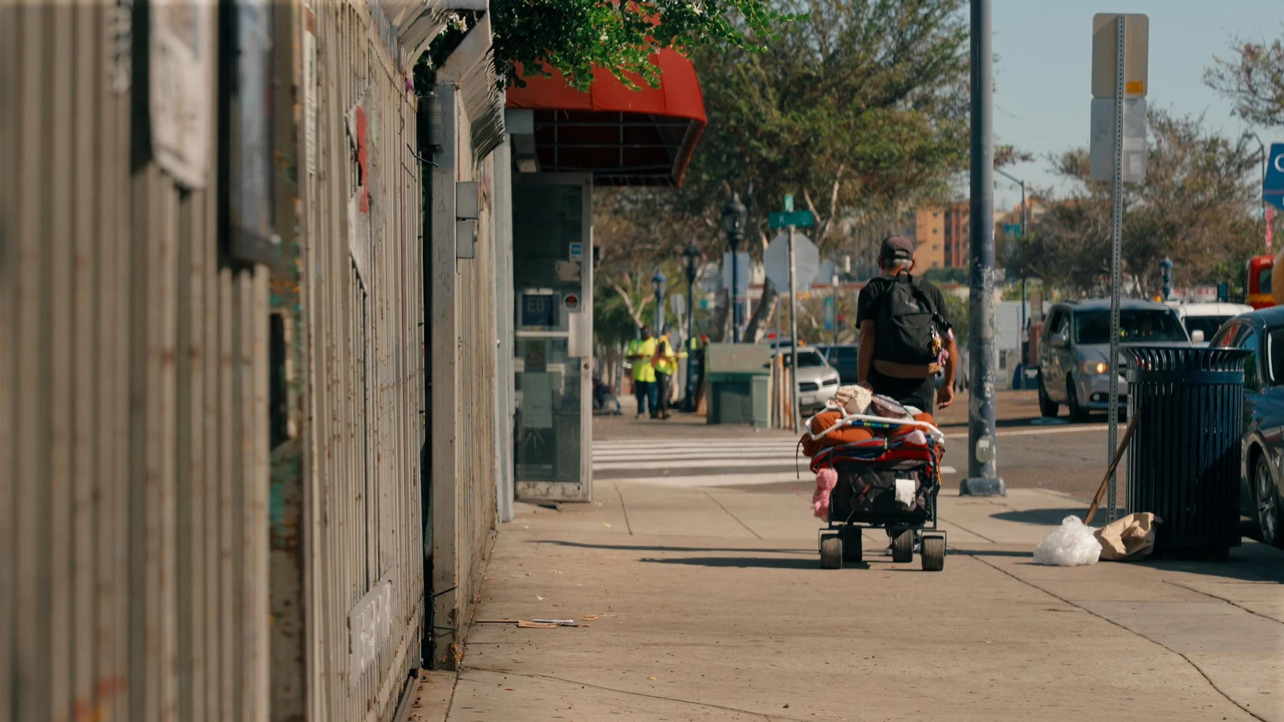 Man walking down sidewalk with cart.jpg