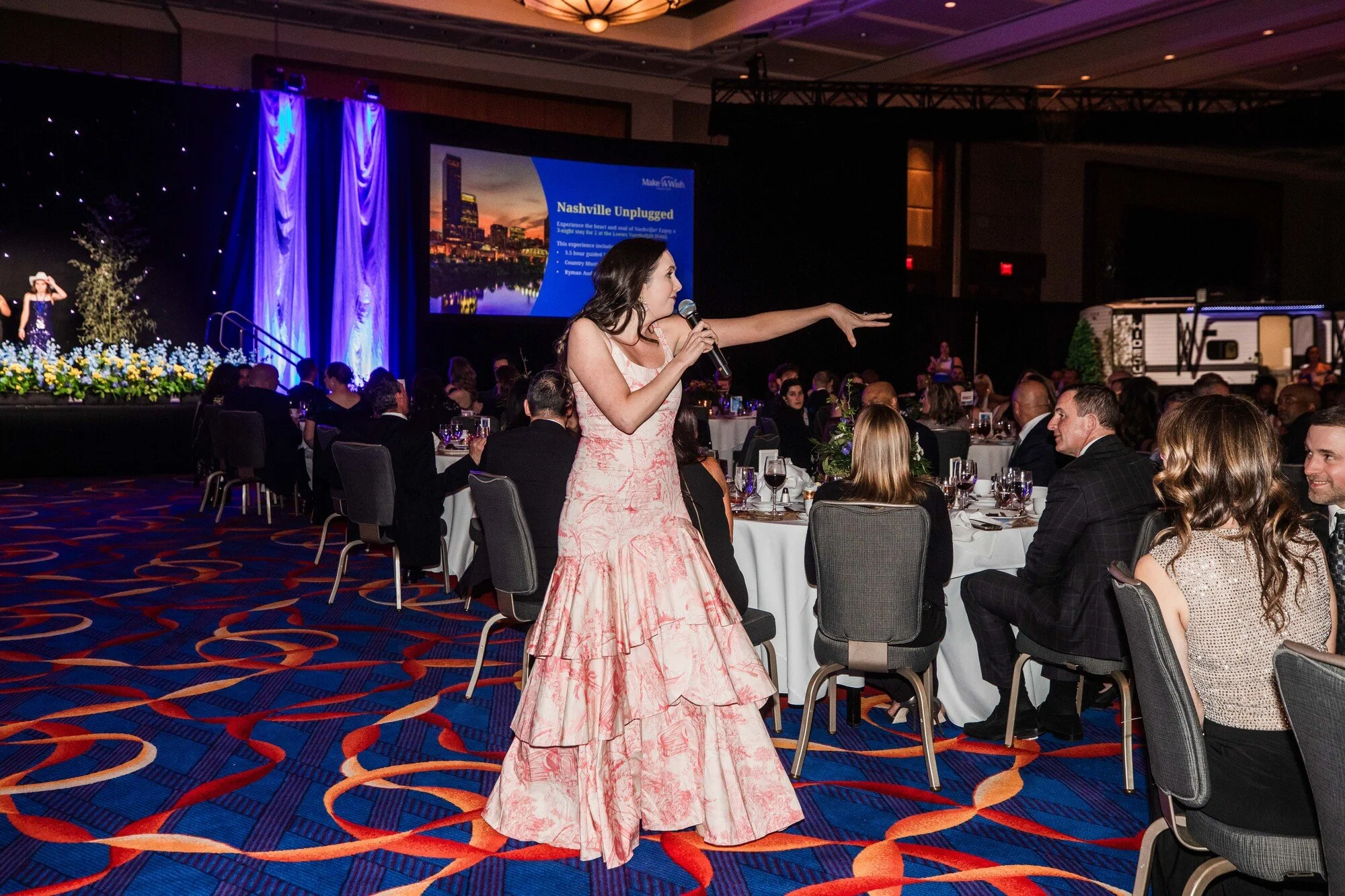Jacqueline engaging the audience during a charity event.