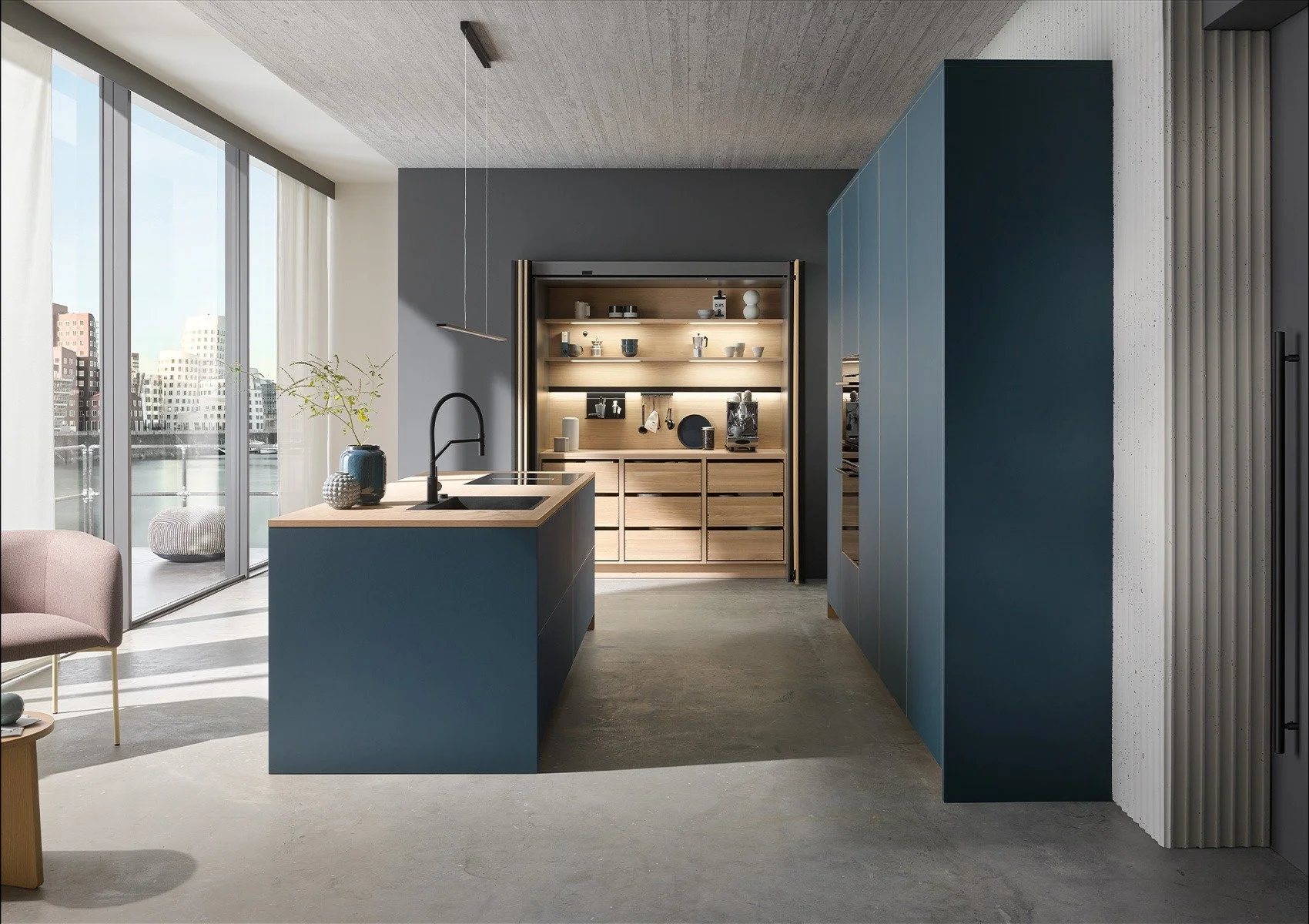 Modern kitchen with blue cabinets, wooden island, and a view of city buildings through large glass windows.