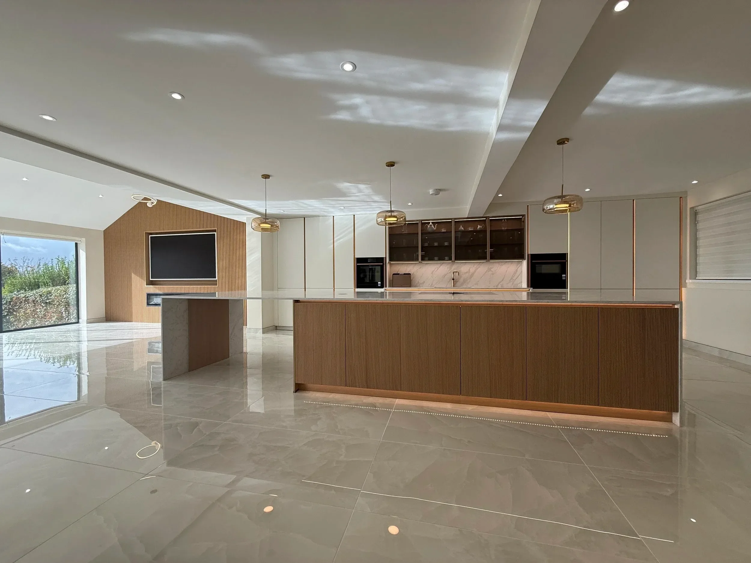 A Striking White and Oak Kitchen with Refined Bronze Details