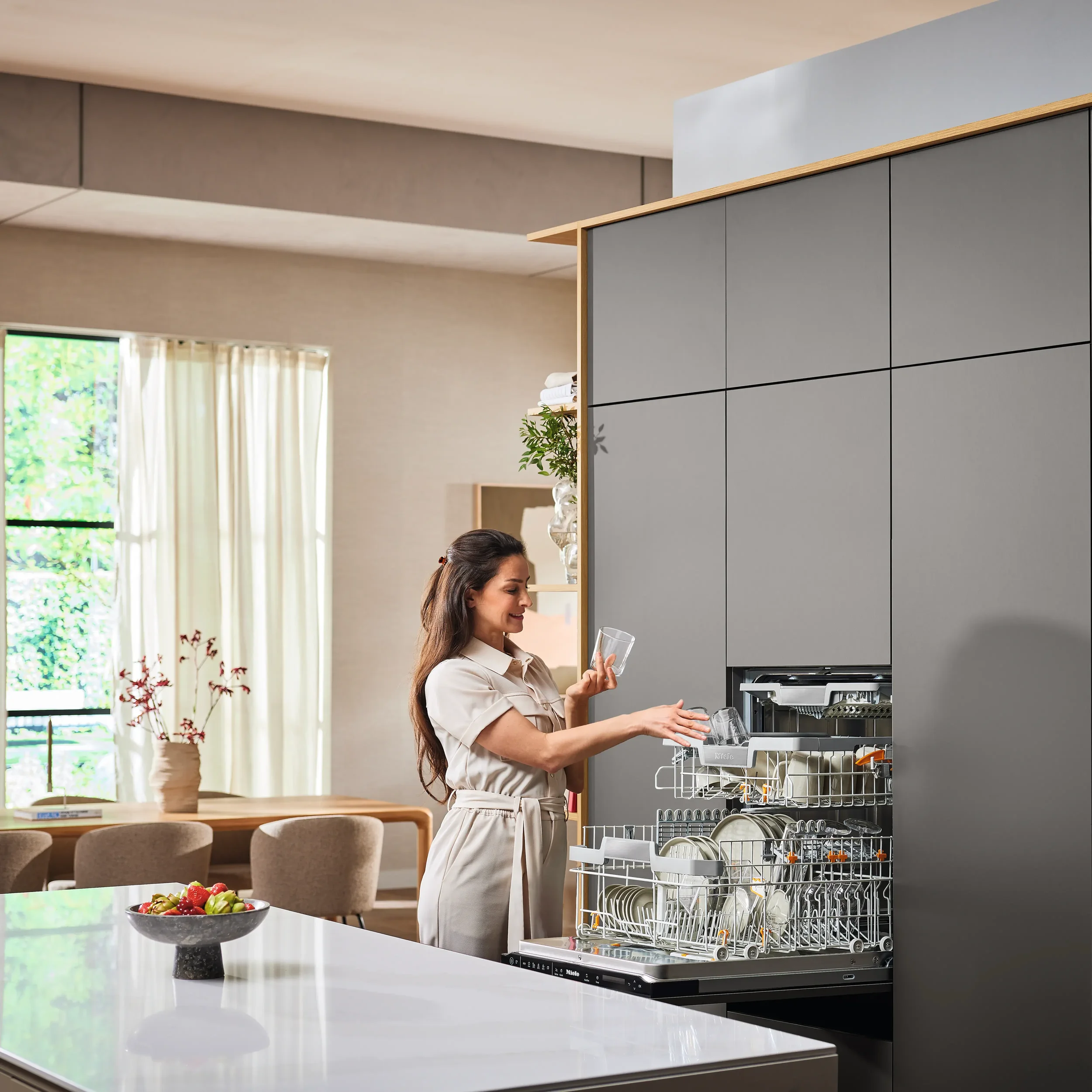 Lady opening an integrated Miele Dishwasher