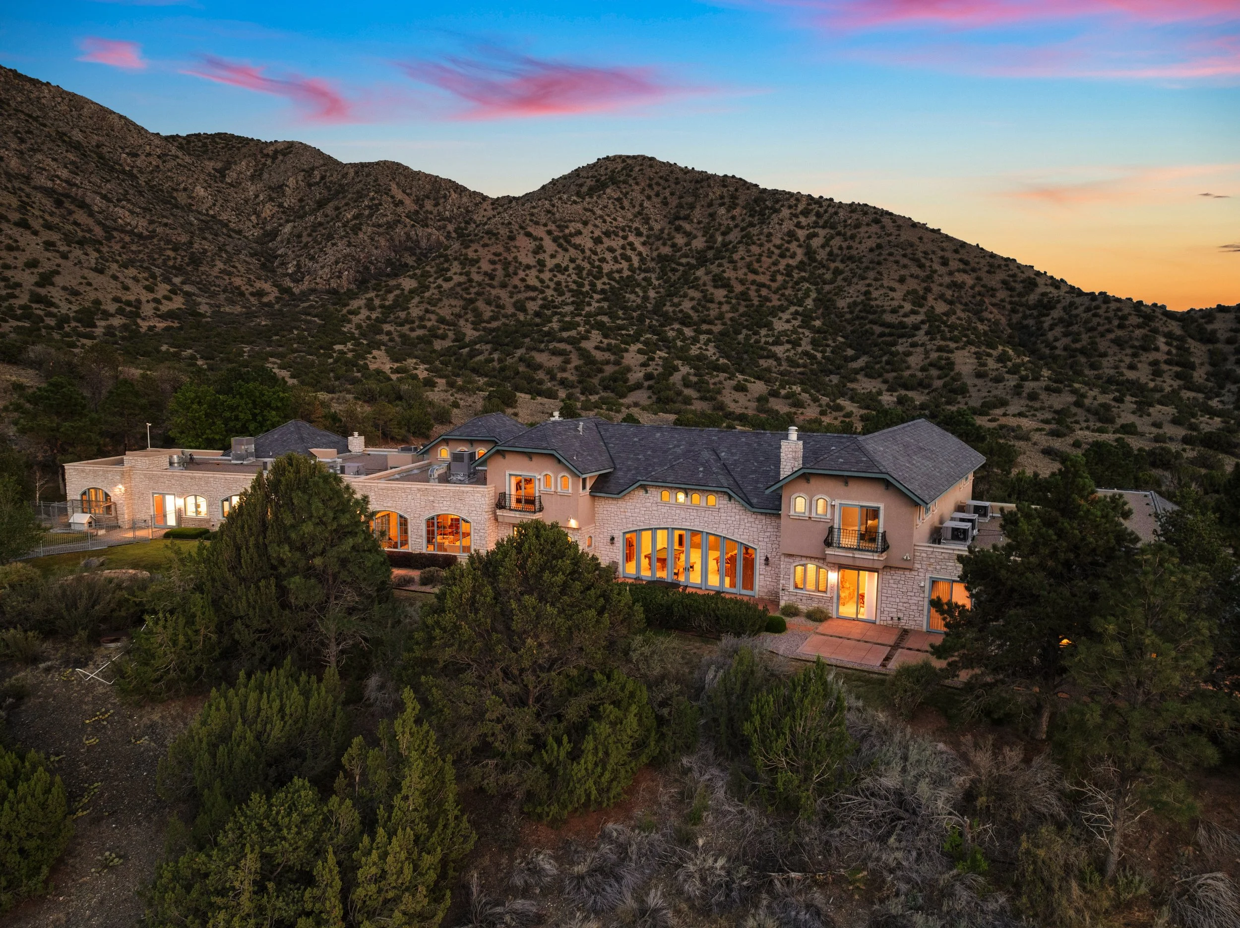 Aerial of hillside estate at dusk